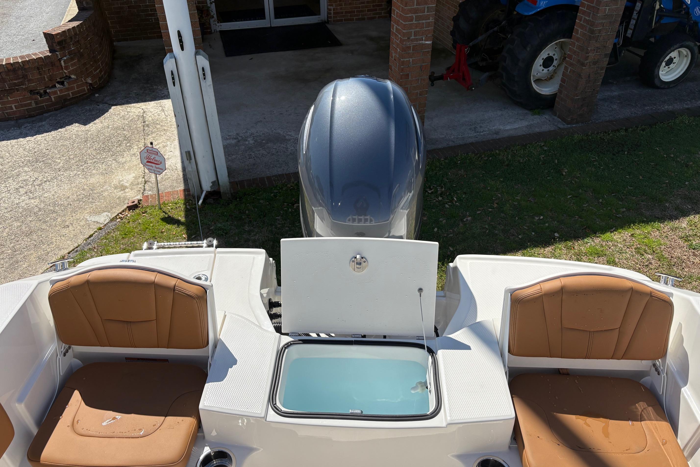 2026 Robalo R180 Center Console boat with open storage compartment and seating.