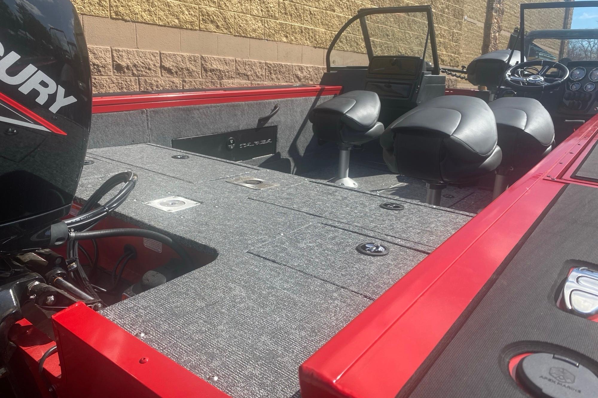 2026 Tracker Targa V-18 WT boat interior with Mercury engine, featuring seating and control panel.