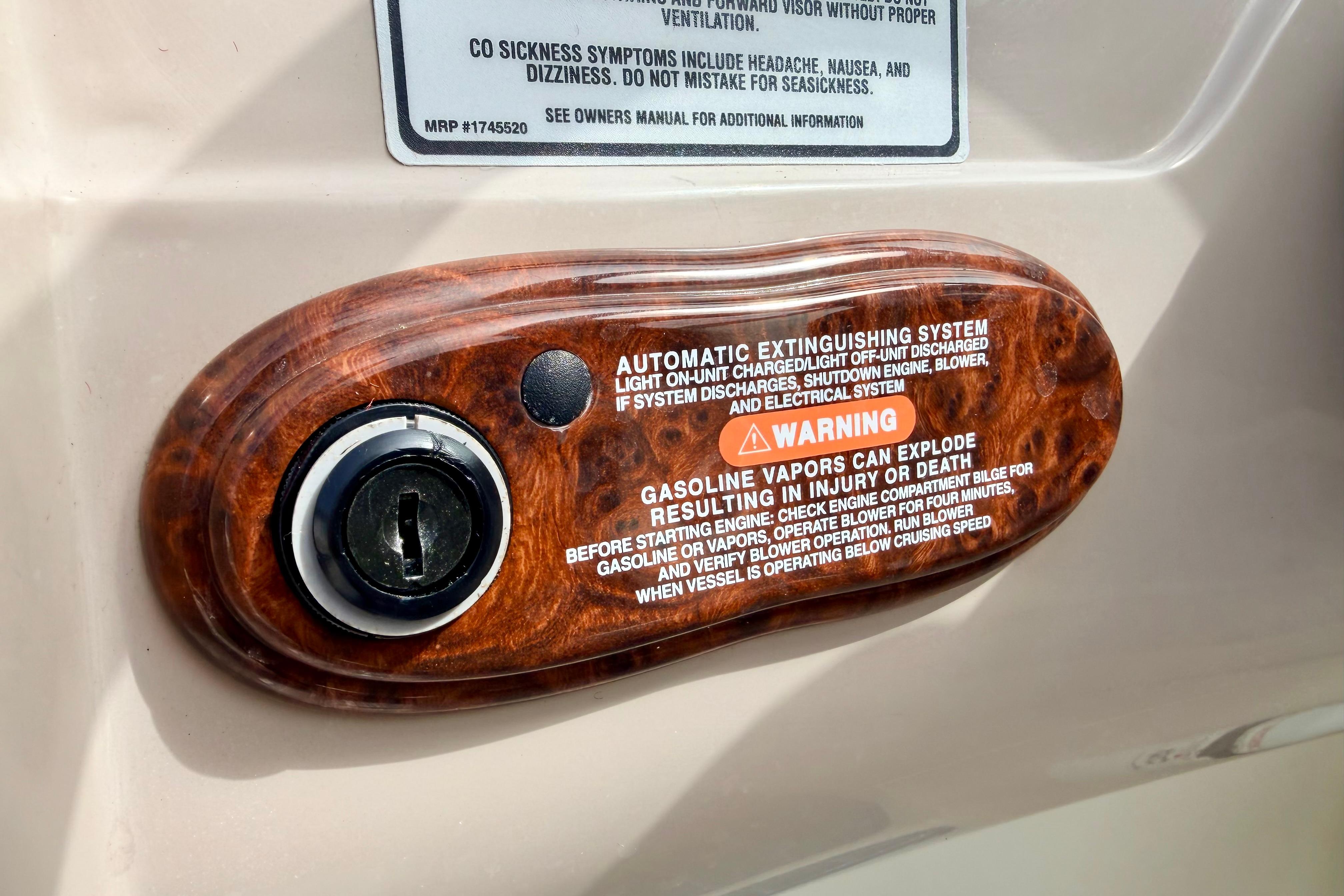 2003 Sea Ray 200 Sundeck ignition switch with safety warning label.