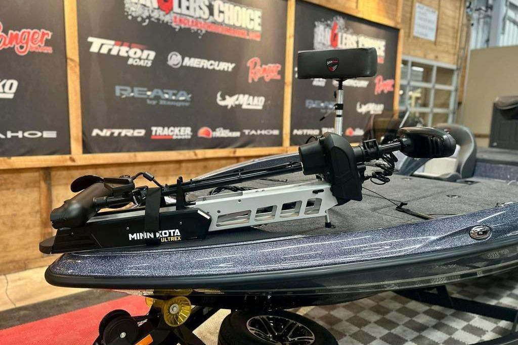 2026 Triton 18 TrX boat with Minn Kota Ultrex trolling motor in showroom.