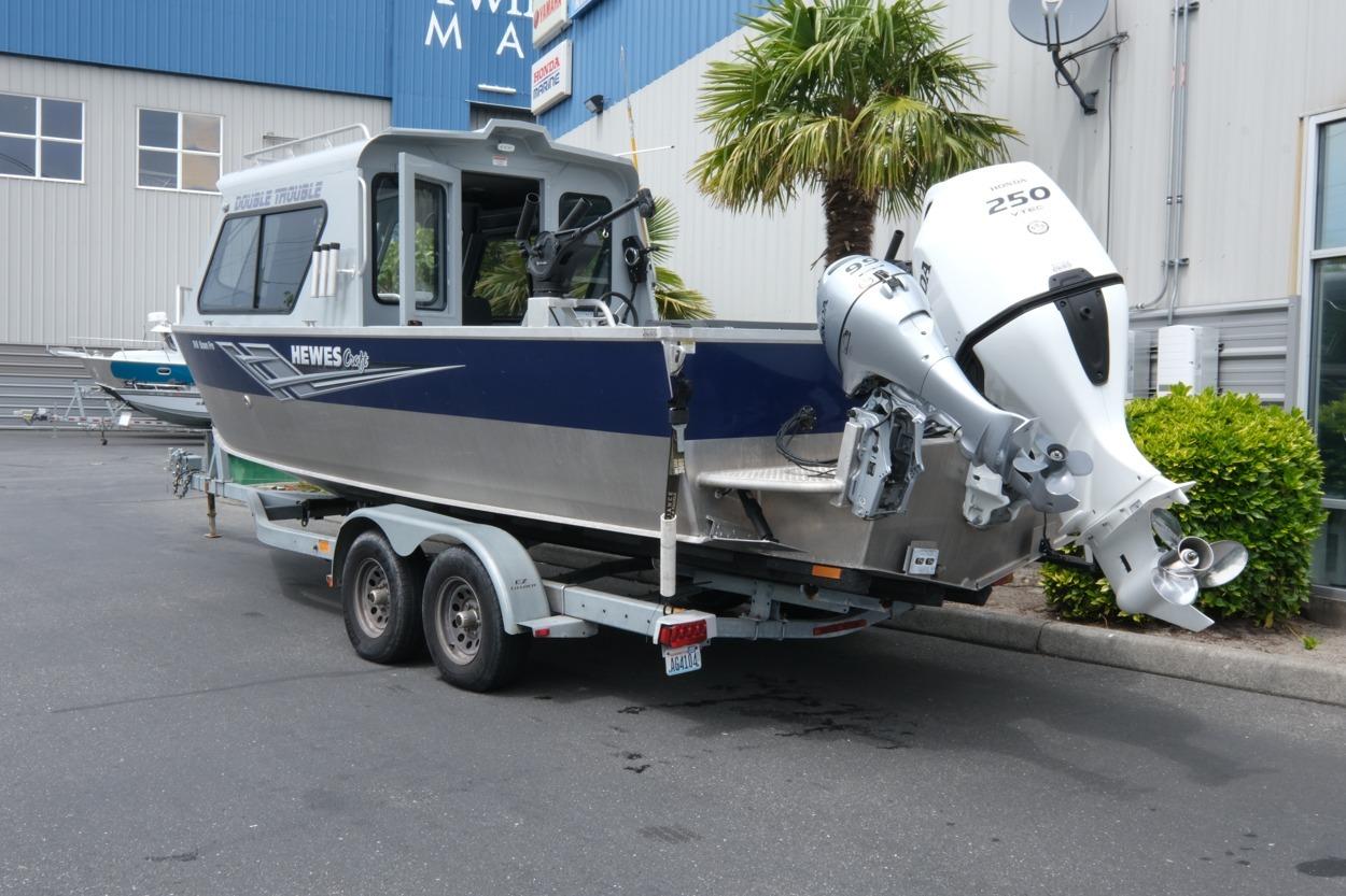 2021 Hewescraft 240 Ocean Pro ET Hardtop boat on trailer, parked outdoors.