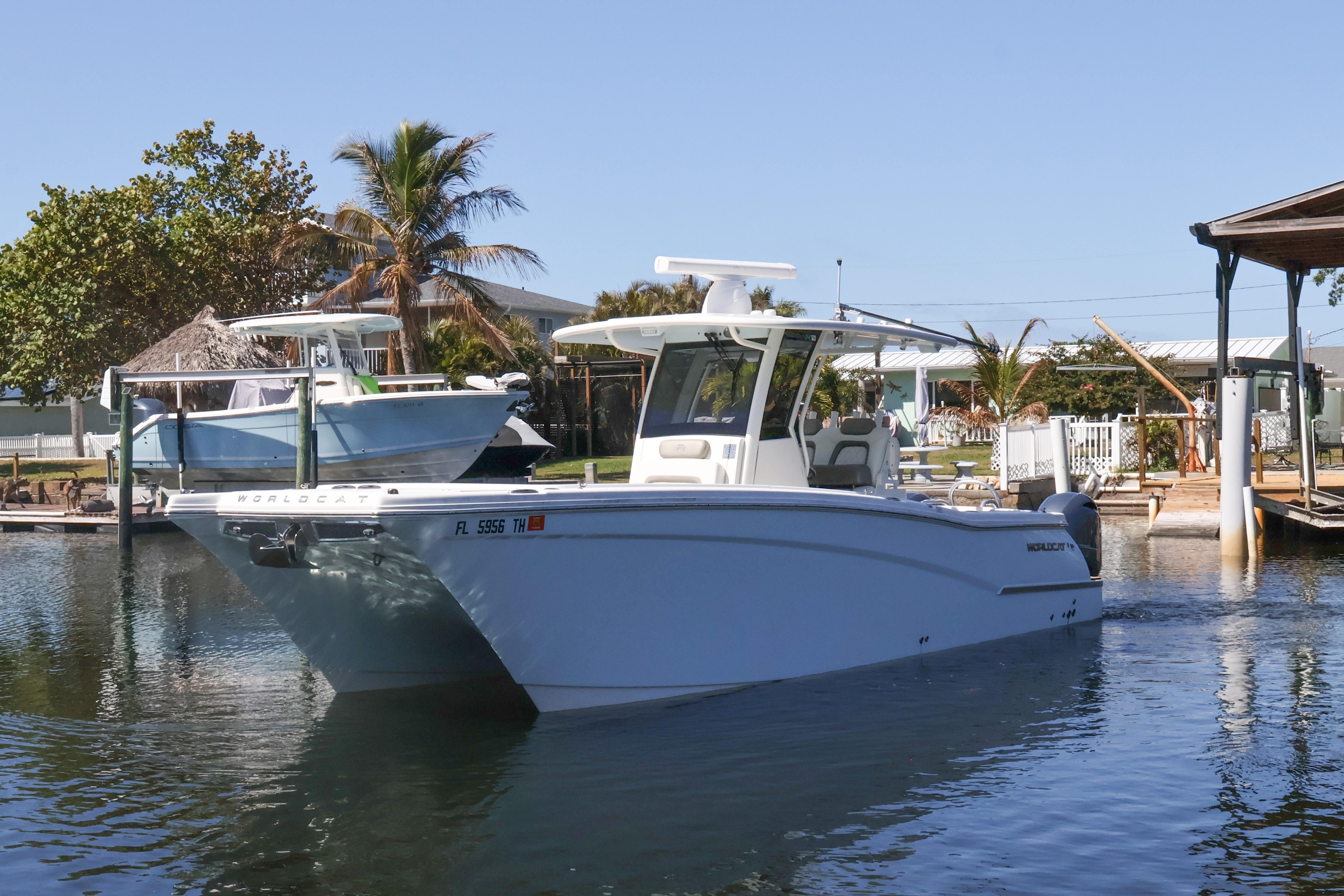 2022 World Cat 280 CC-X boat docked in a serene marina setting.