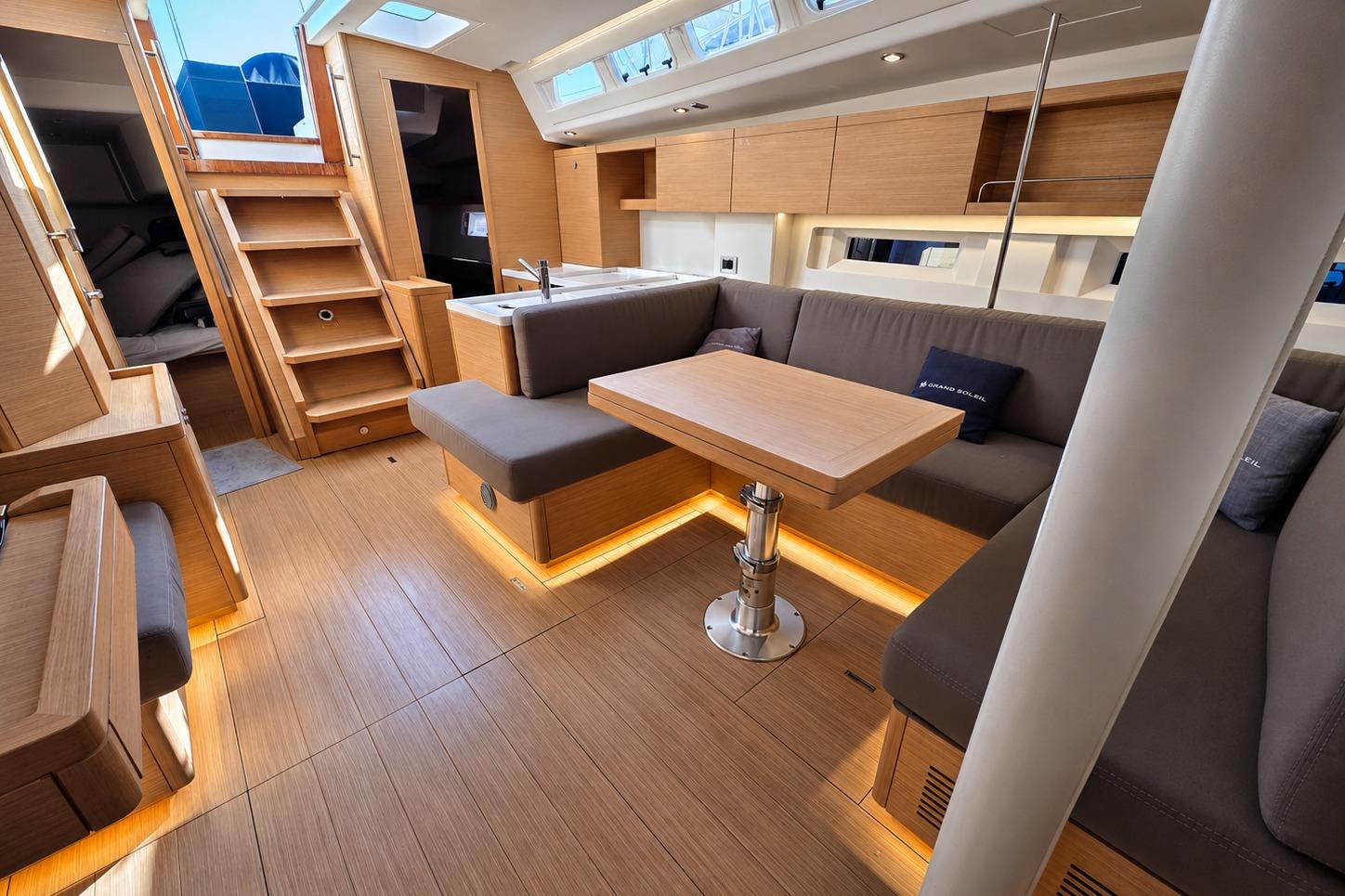 Luxurious interior of 2020 Grand Soleil 42 LC yacht with modern wood finish.