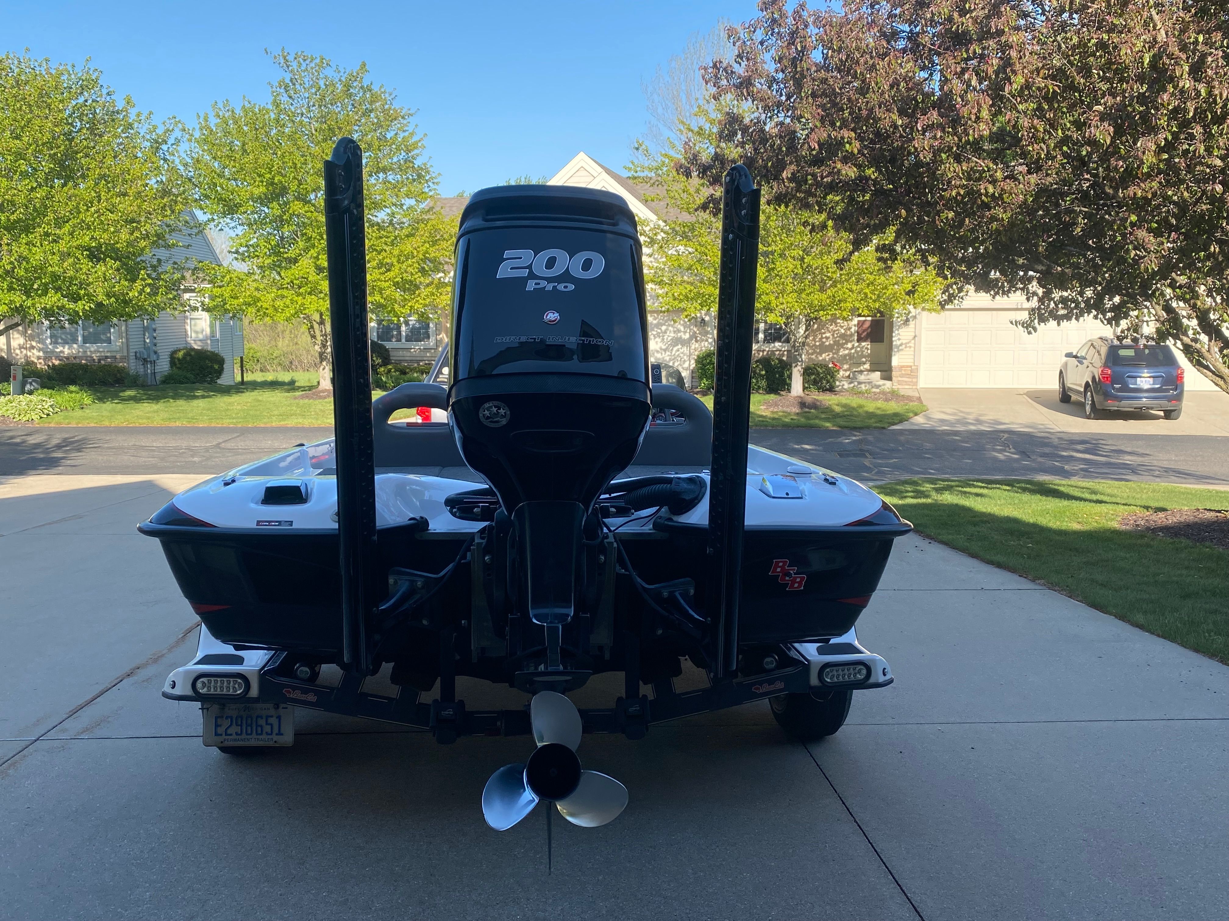 A 2014 Bass Cat Pantera II boat is on a driveway. It features a 200 HP engine.