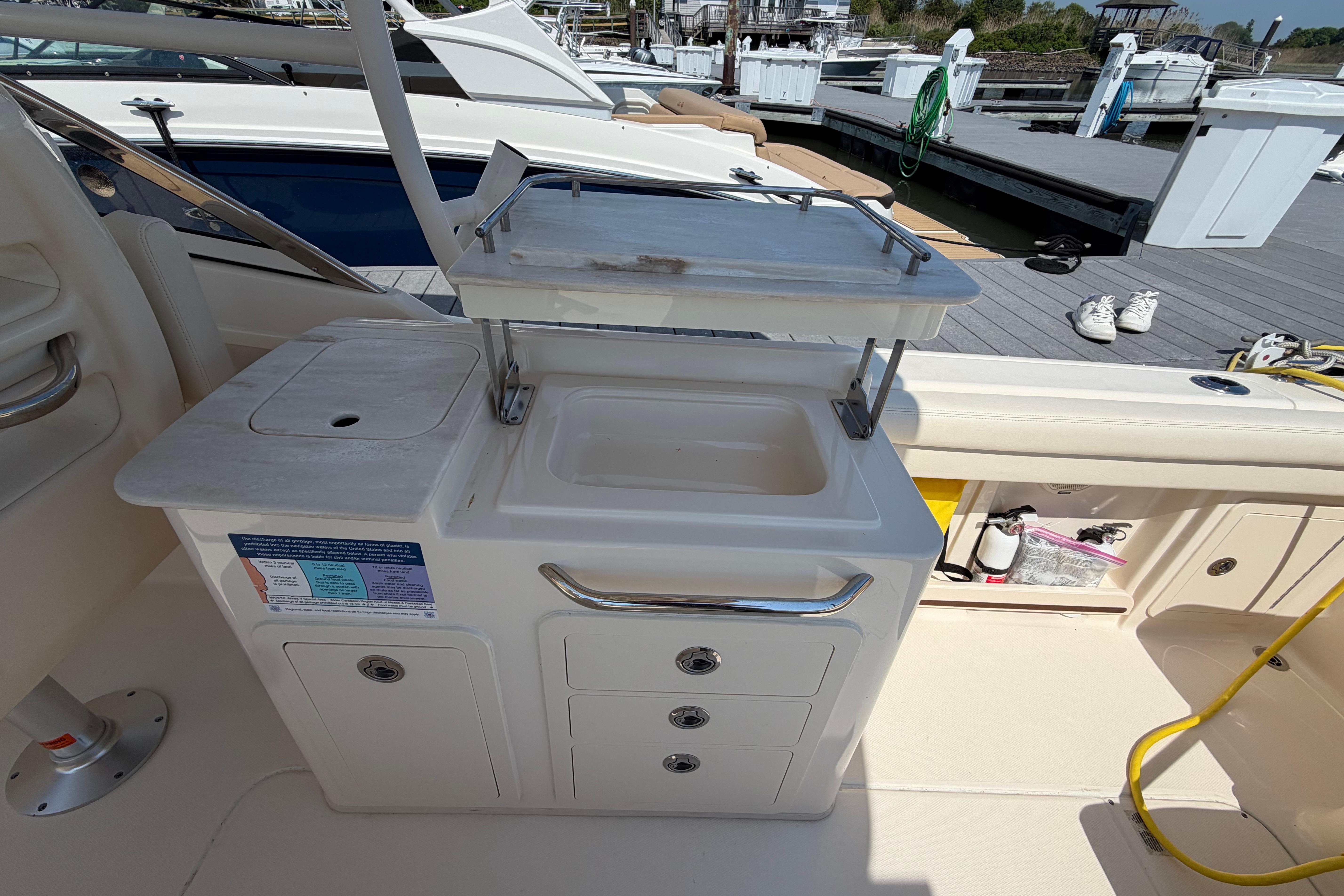 2018 Grady-White Freedom 275 boat interior with sink and storage compartments.