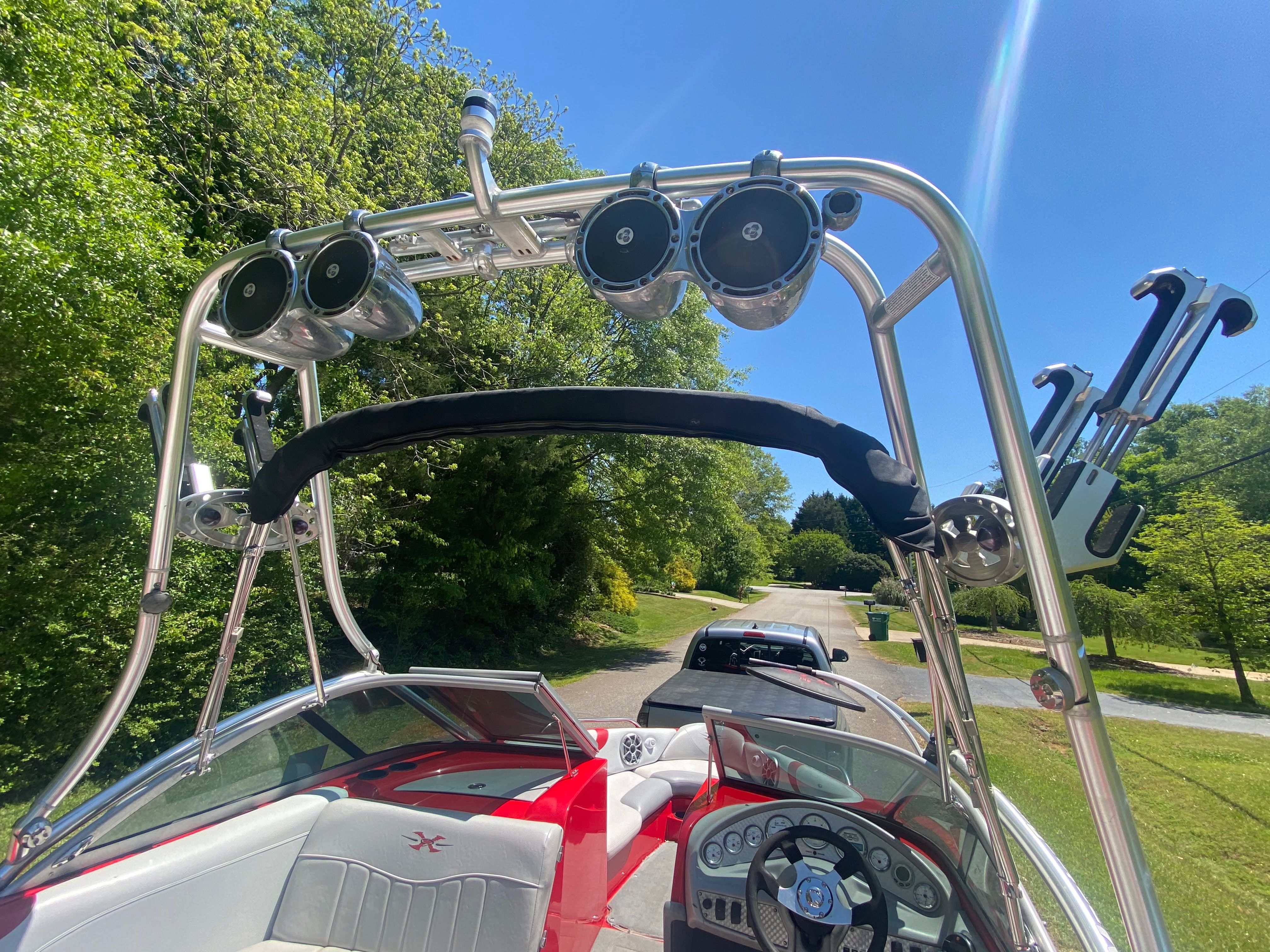 The image shows the cockpit of a 2004 MasterCraft X-9 boat with a sturdy tower.