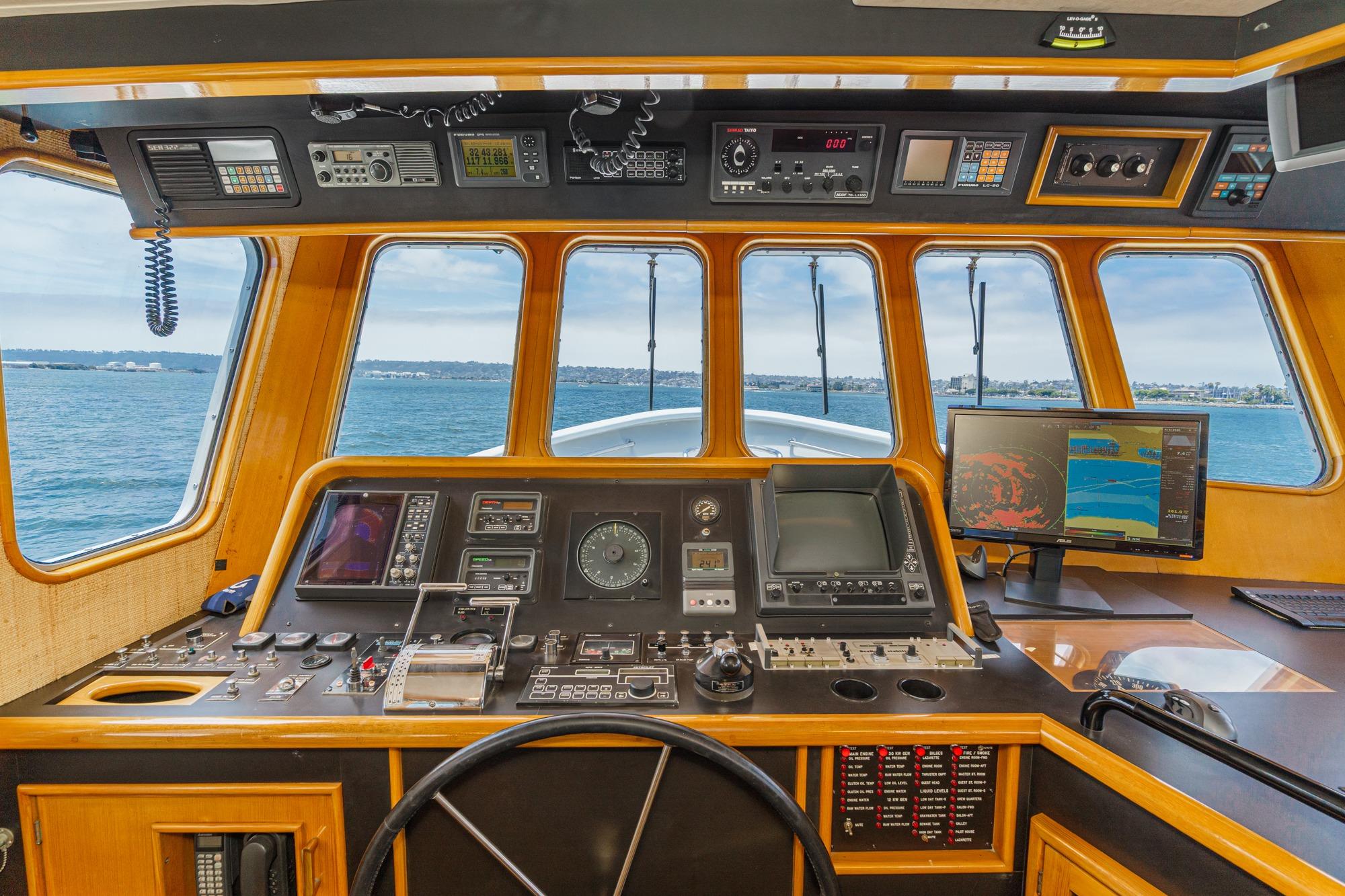 Cockpit of a 1990 Seaton Long Range Cruiser with navigation equipment and ocean view.