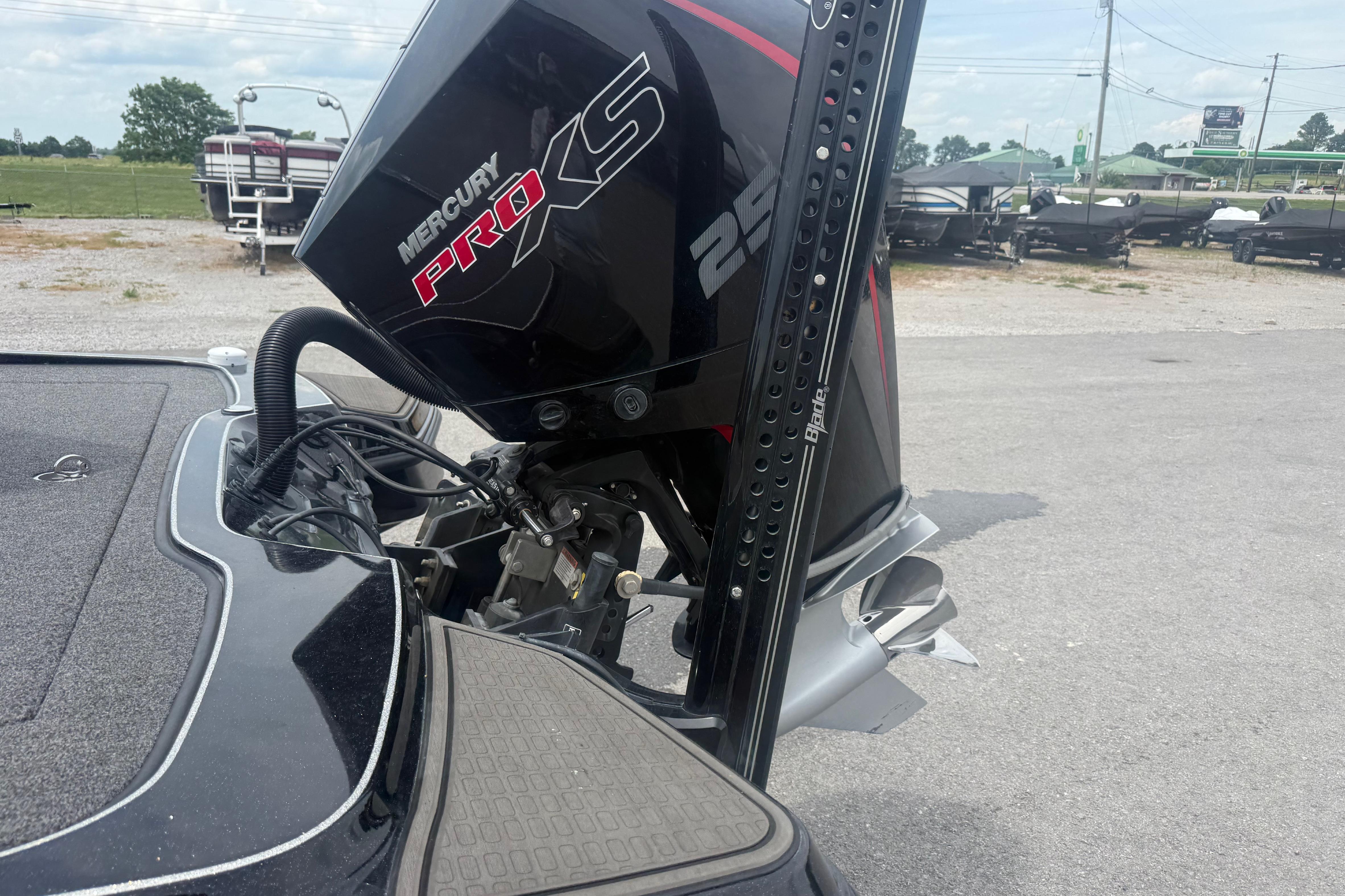 2024 Triton 20XP boat with Mercury Pro XS 250 outboard motor in a parking area.