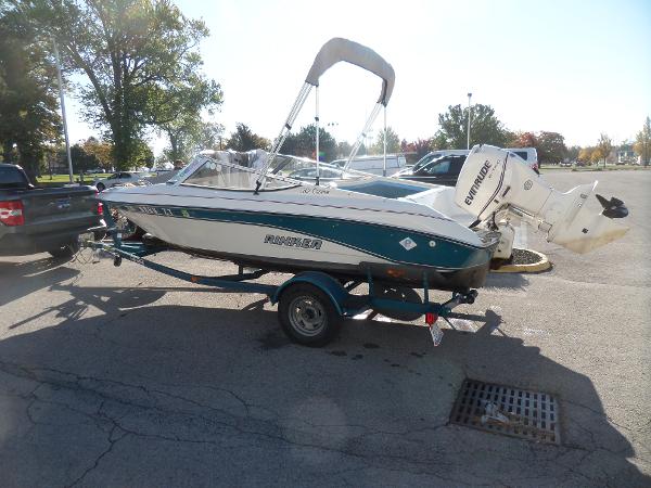 1992 Rinker Captiva 170 OB boat on trailer in parking lot.