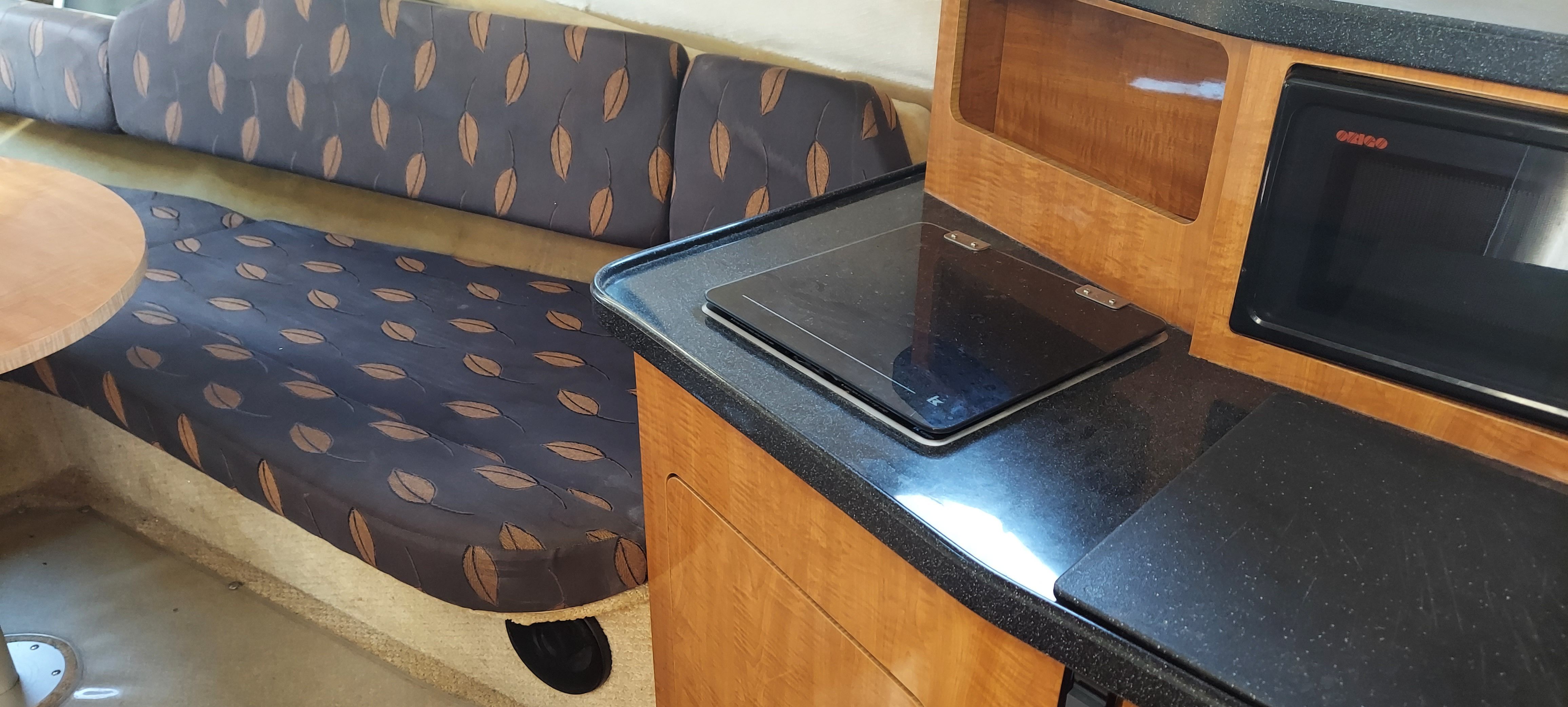 Interior of a 2004 Regal Commodore 2465 yacht with kitchen and seating area.