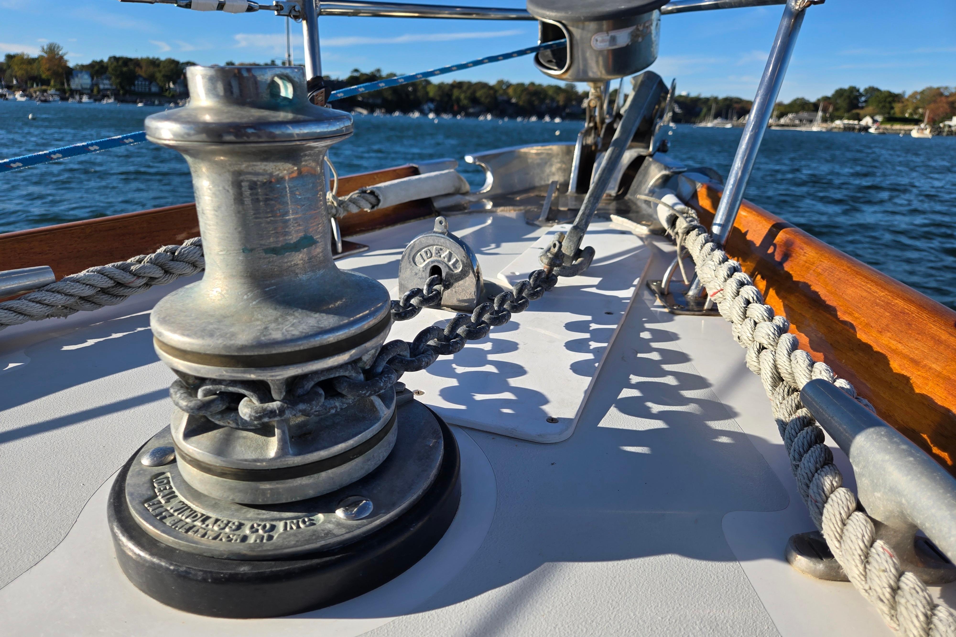 Deck view of a 1970 Hinckley Bermuda 40 sailboat with winch and ropes.