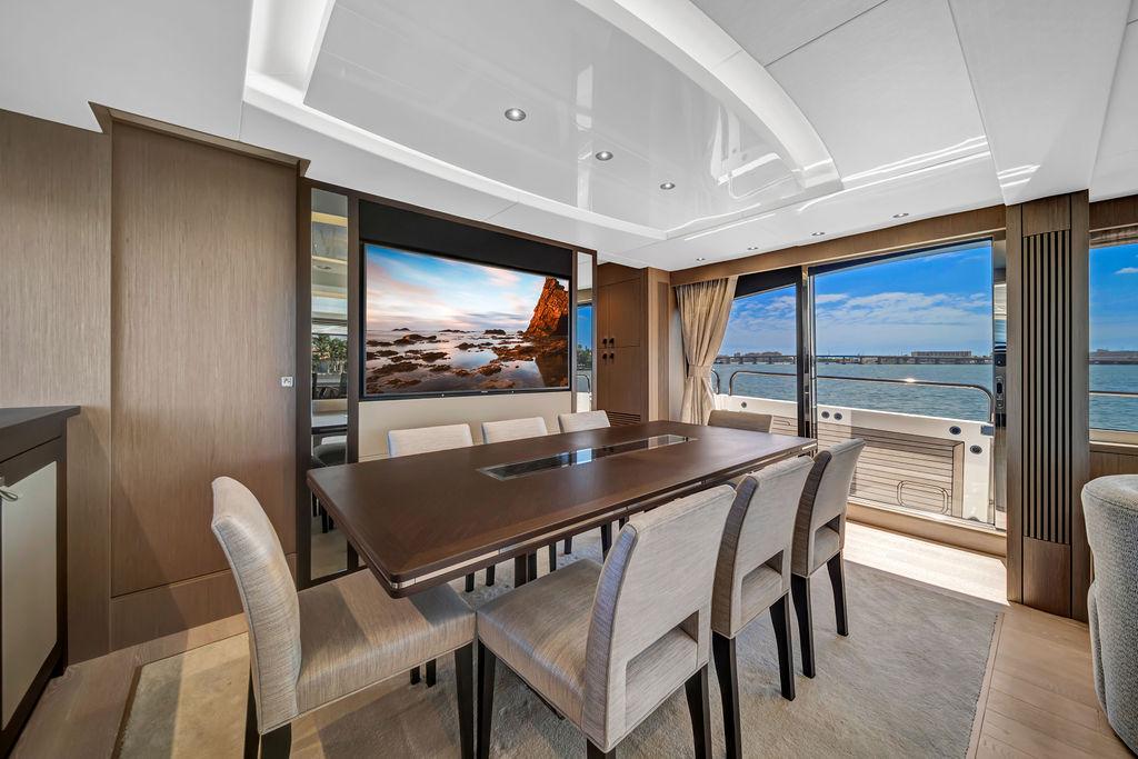 Luxurious dining area on a 2021 Sunseeker 86 Yacht with ocean views.