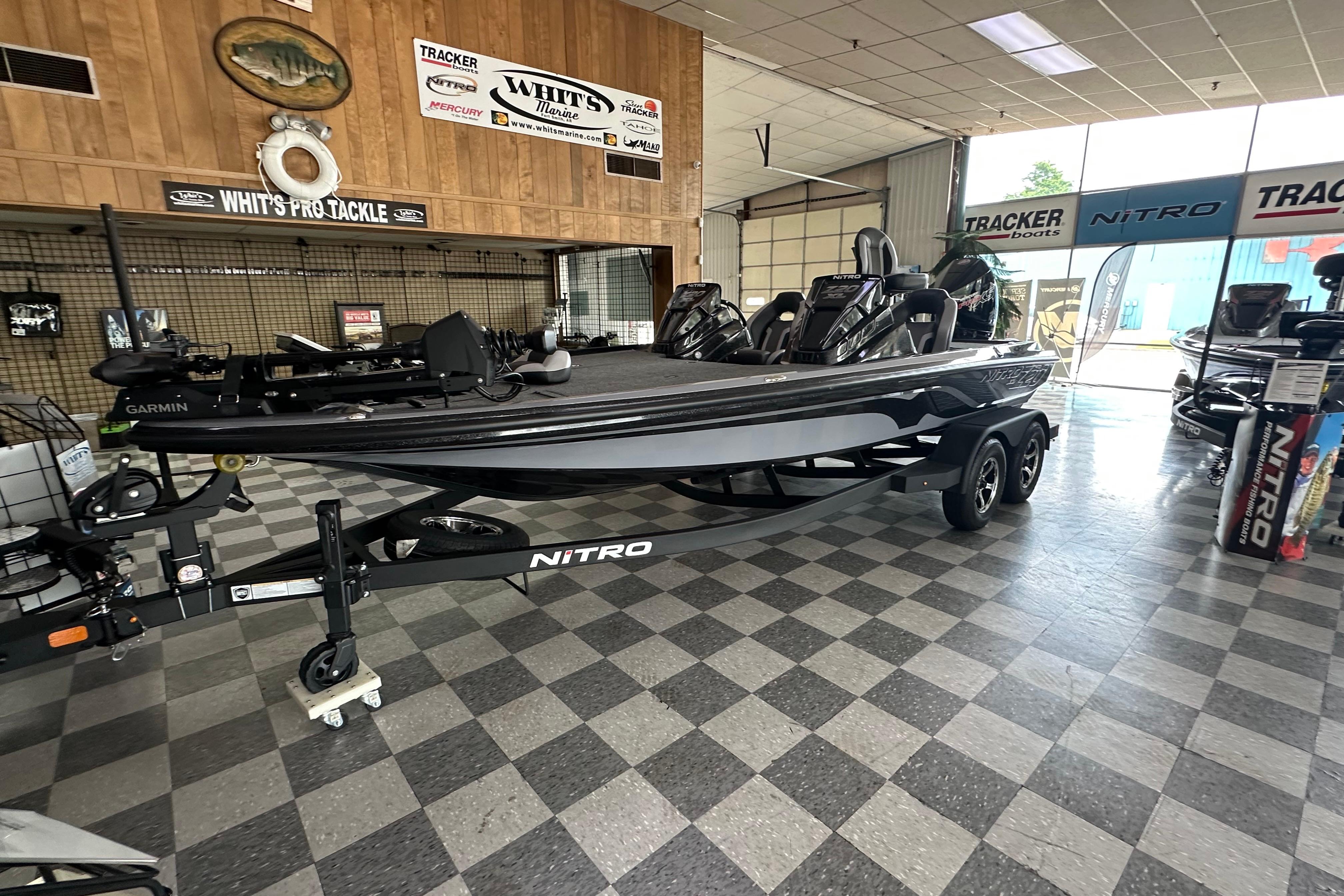 2025 Nitro Z20 XL Pro boat displayed in showroom with checkered floor and wooden walls.