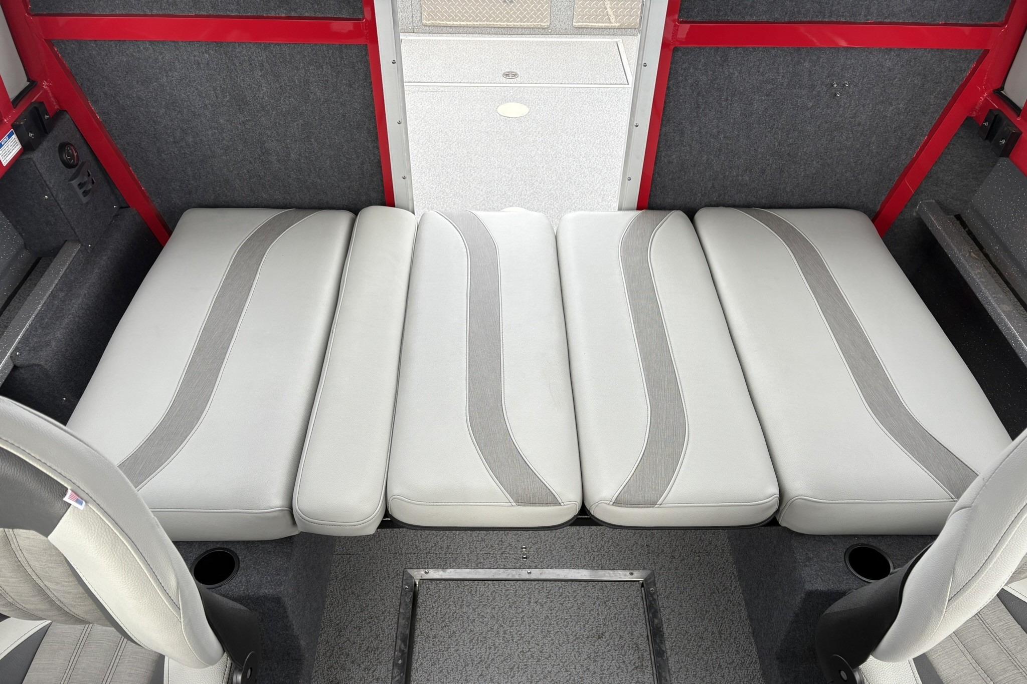 2024 Spartan 240 Maximus Pro interior with gray cushioned seating and red accents.