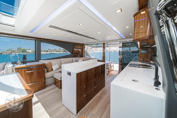 Luxurious interior of the 2025 Riviera 645 SUV yacht with modern amenities and waterfront view.