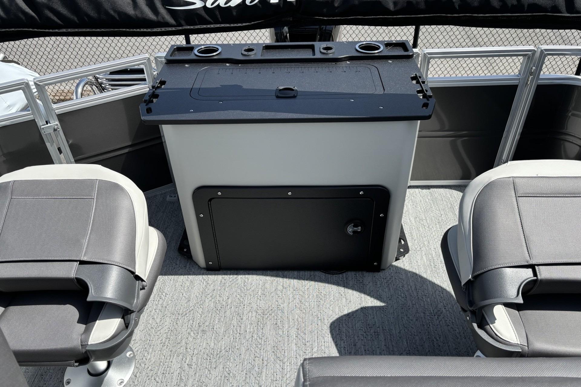 2026 Sun Tracker Fishin' Barge 20 DLX interior with seating and storage console.