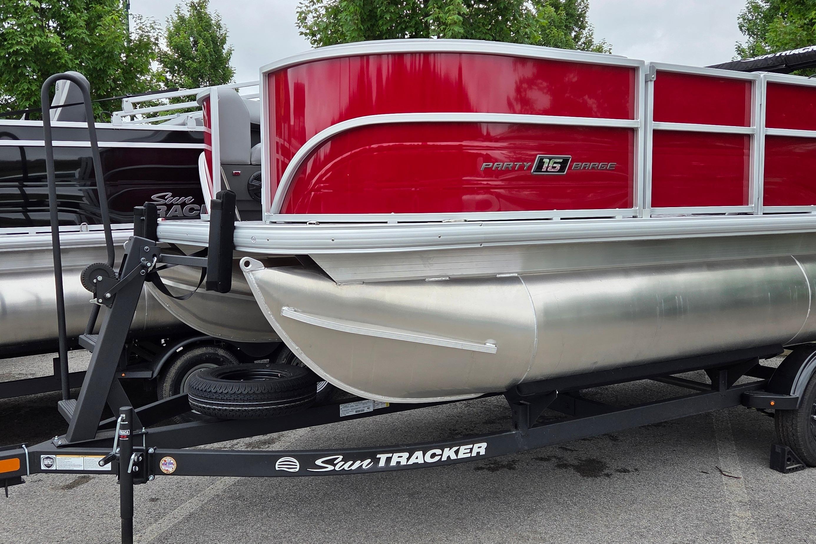 2026 Sun Tracker Party Barge 16 DLX pontoon boat on trailer, featuring red and silver design.