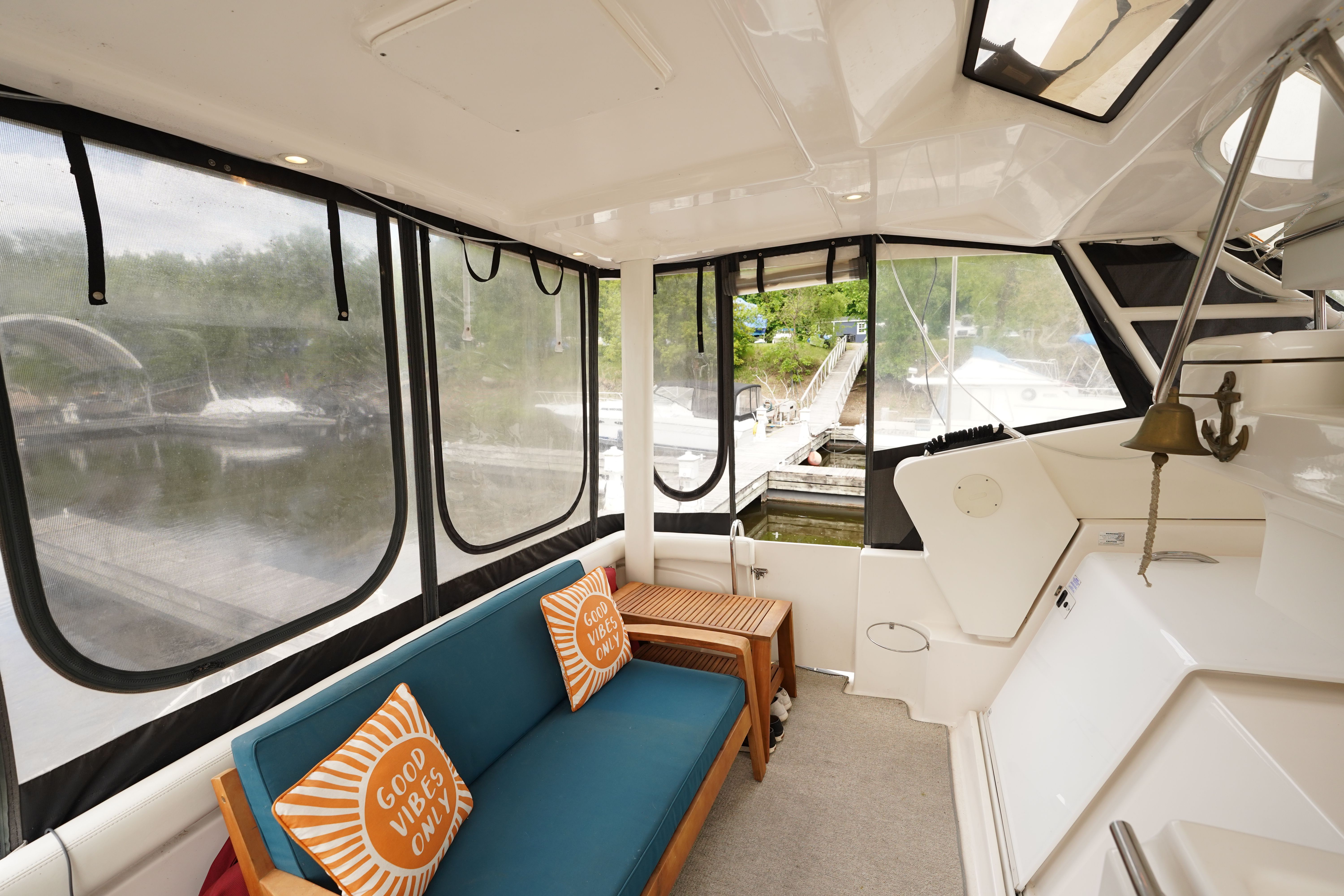 Interior of a 2002 Silverton 352 Motor Yacht with sofa and cushions.
