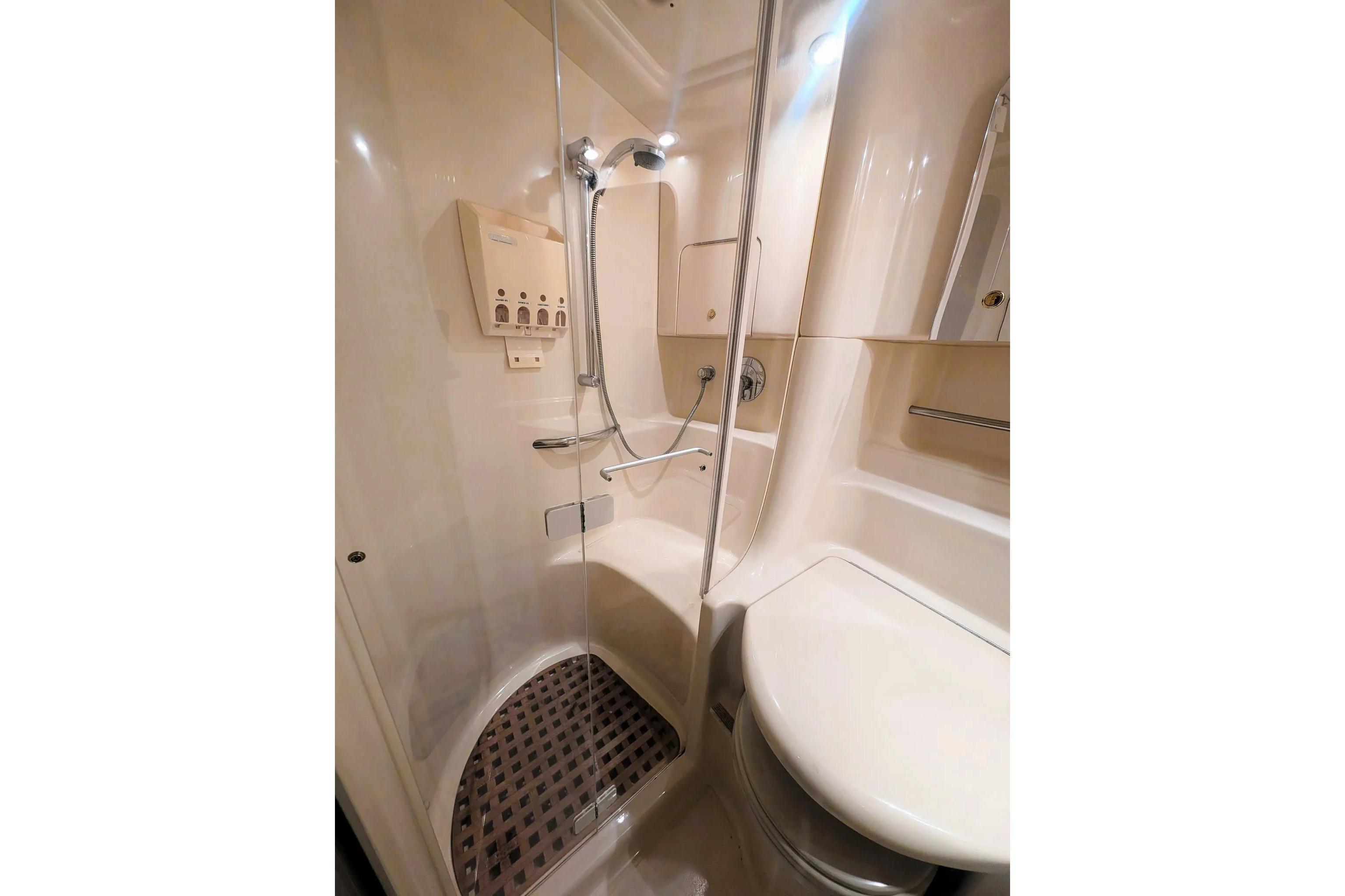 Bathroom interior of 2000 Sea Ray 380 Sundancer yacht, featuring shower and sink.