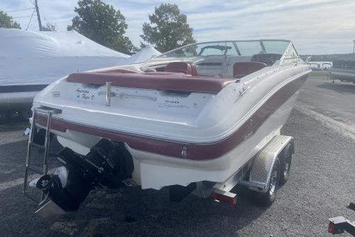 1997 Sea Ray 230 Overnighter boat on trailer, parked outdoors.