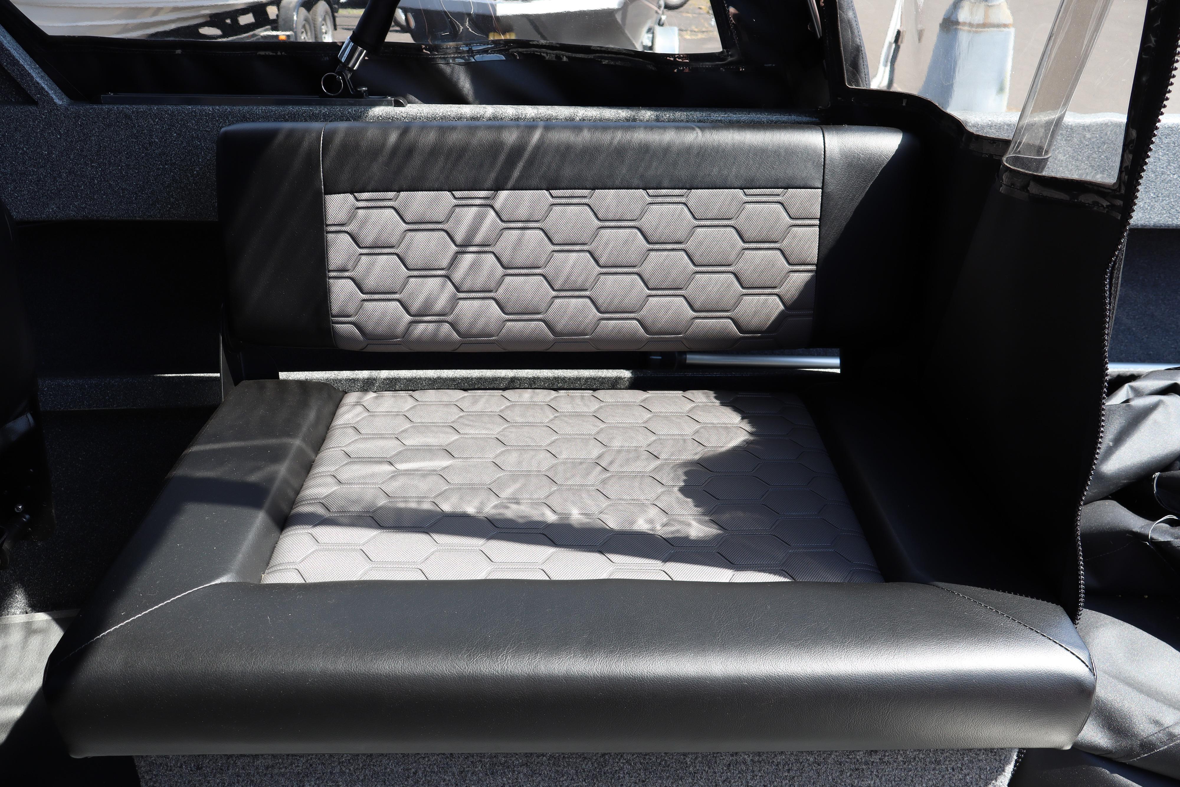 2025 NorthRiver SEAHAWK boat interior with hexagonal-patterned seating and sleek black trim.