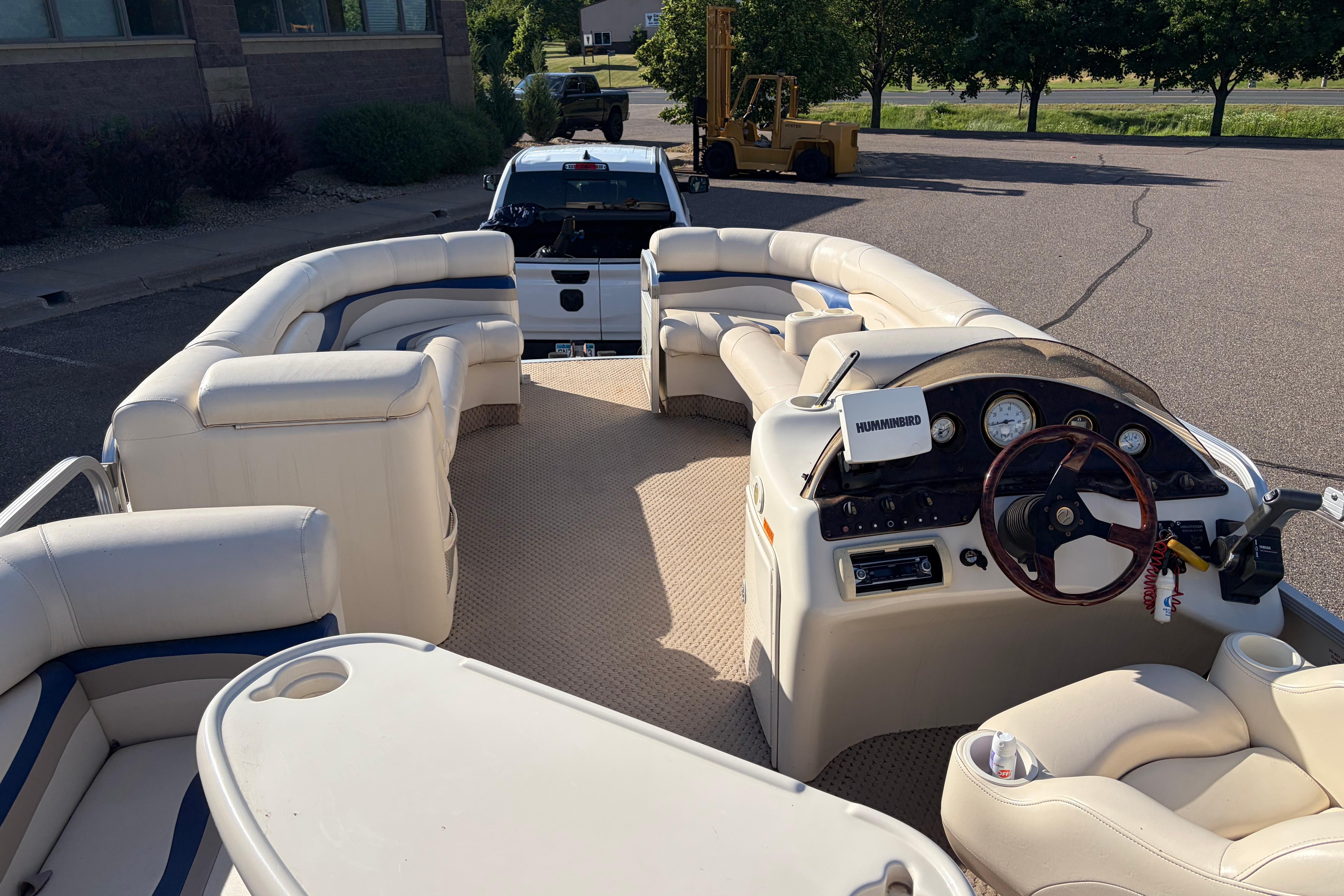 2003 Bennington 2250RSi pontoon boat interior with plush seating and steering console.