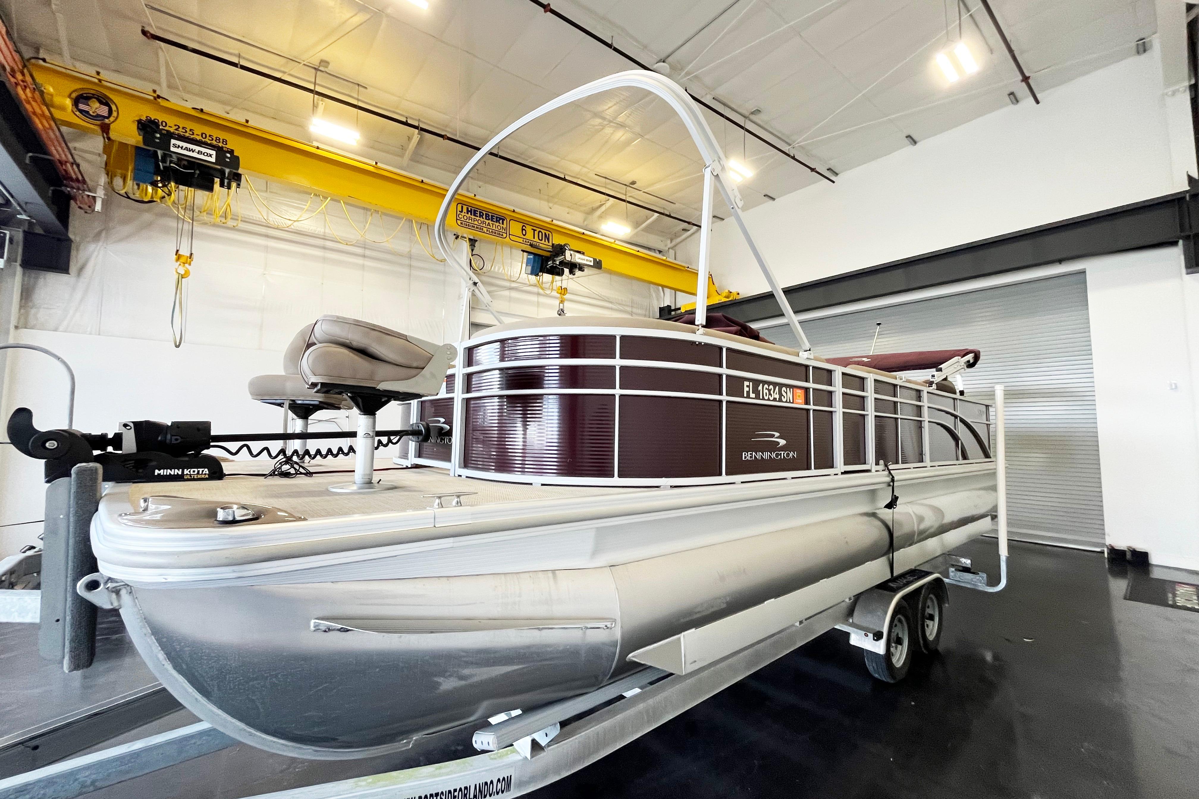 2020 Bennington SX25 pontoon boat on trailer in indoor storage facility.