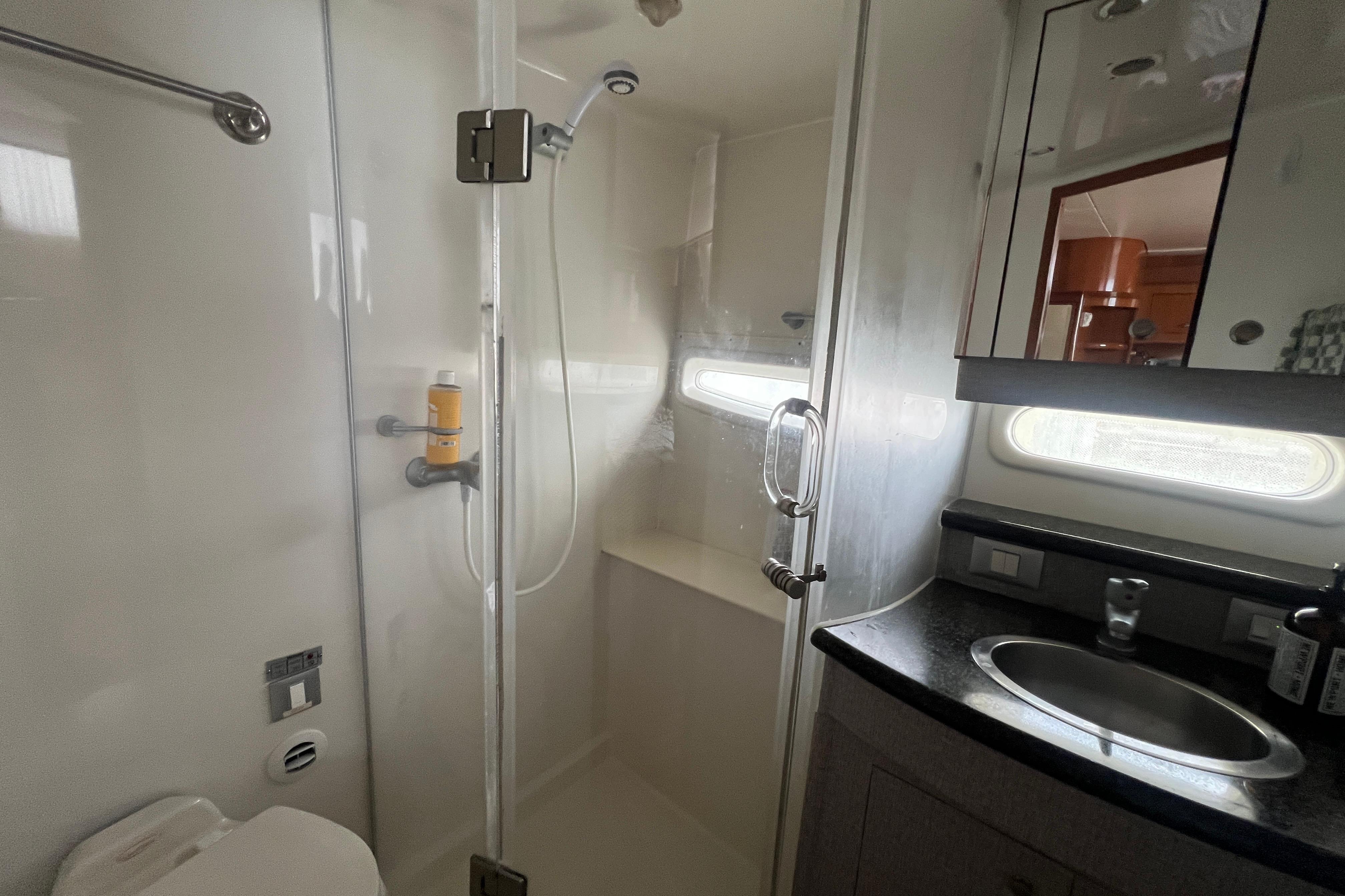 Bathroom interior of 2006 Carver 43 Motor Yacht with shower and sink.