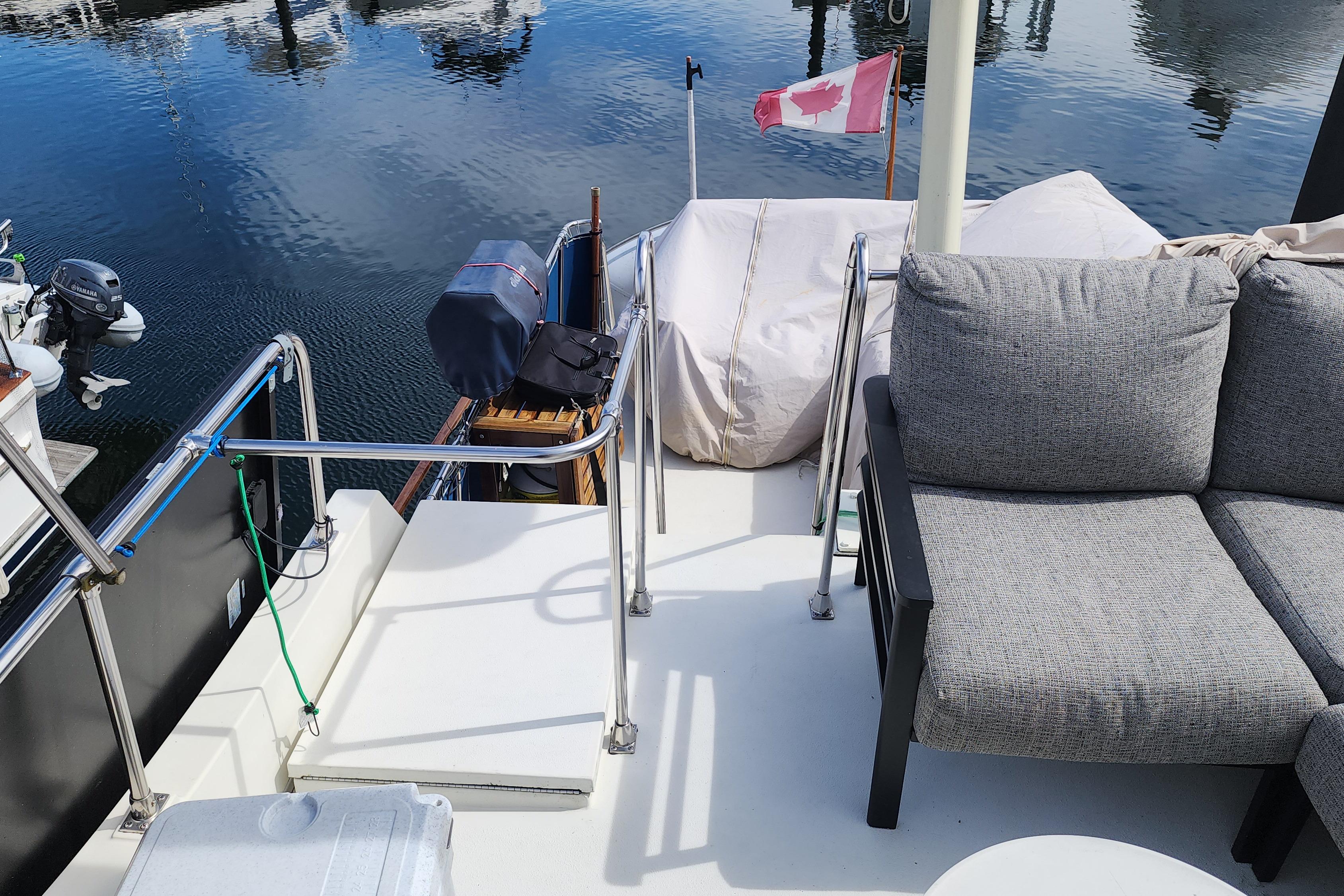 1981 Tollycraft 43 yacht deck with seating, Canadian flag, and water view.