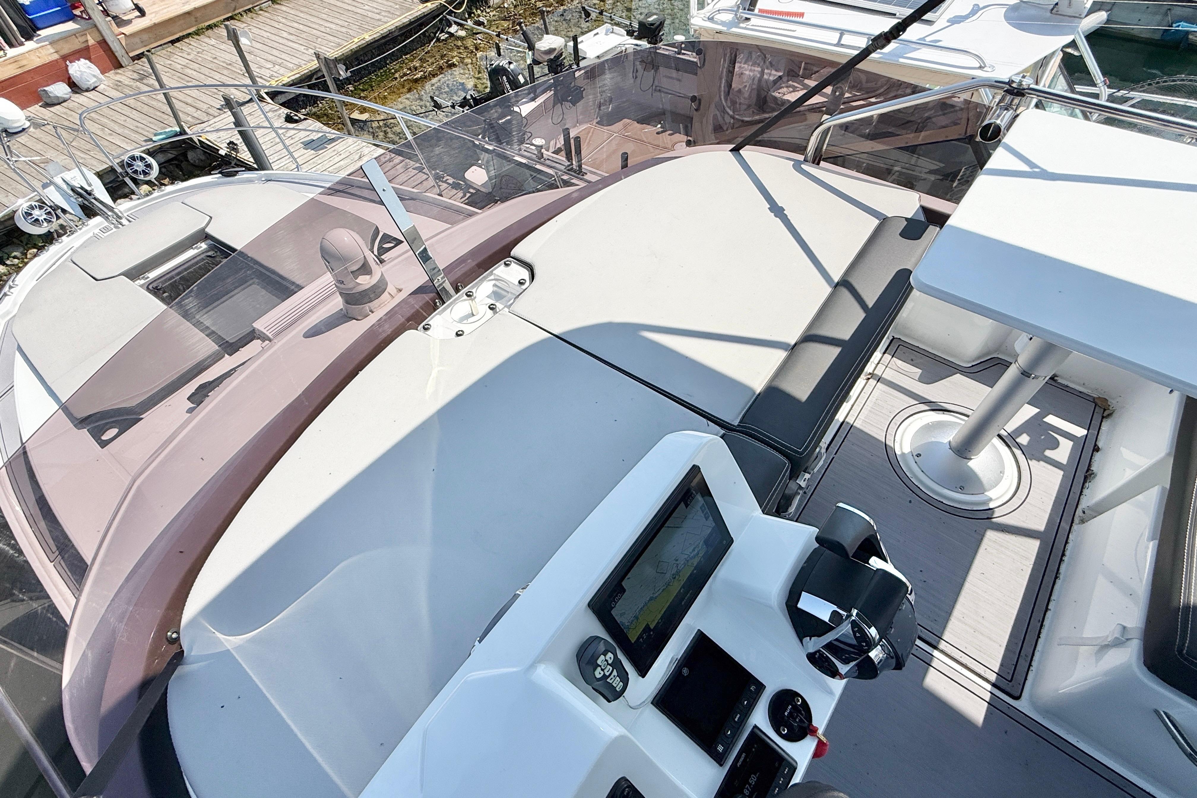 2022 Jeanneau NC 1095 Flybridge with helm, seating, and navigation equipment.