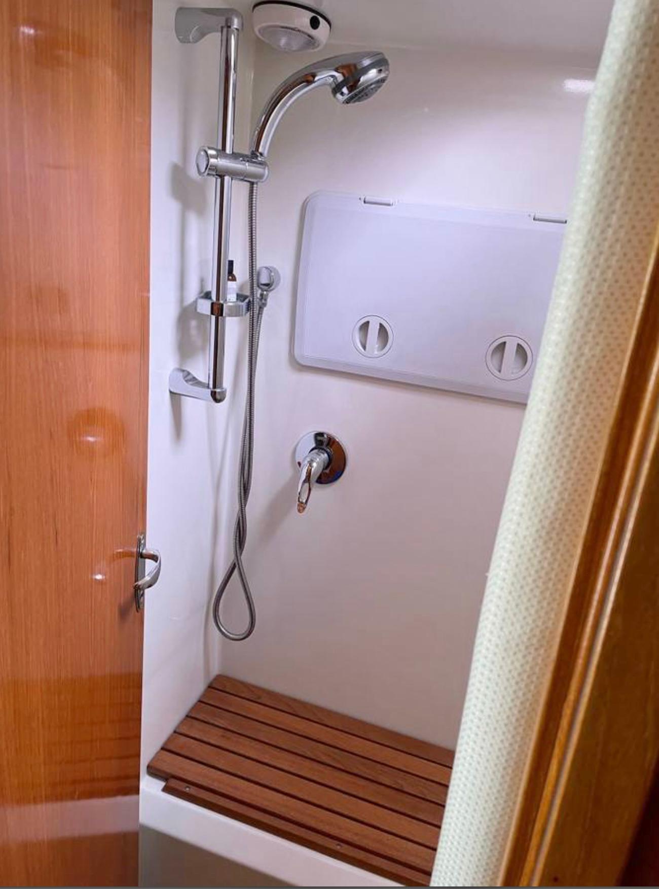 Shower area in 2007 Coastal Craft 36 Cruiser with wooden bench and modern fixtures.