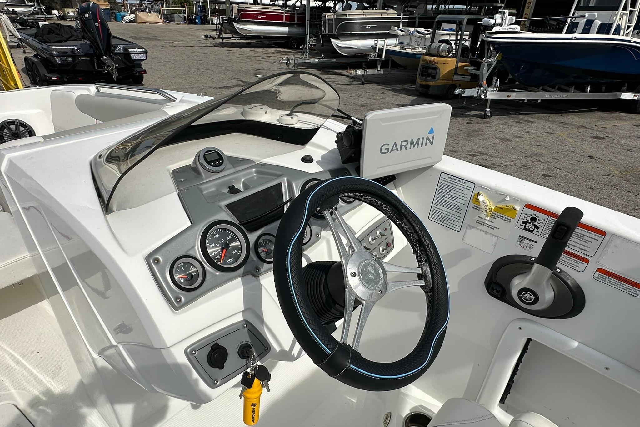 2021 Tahoe 2150 boat dashboard with Garmin navigation system and steering wheel.