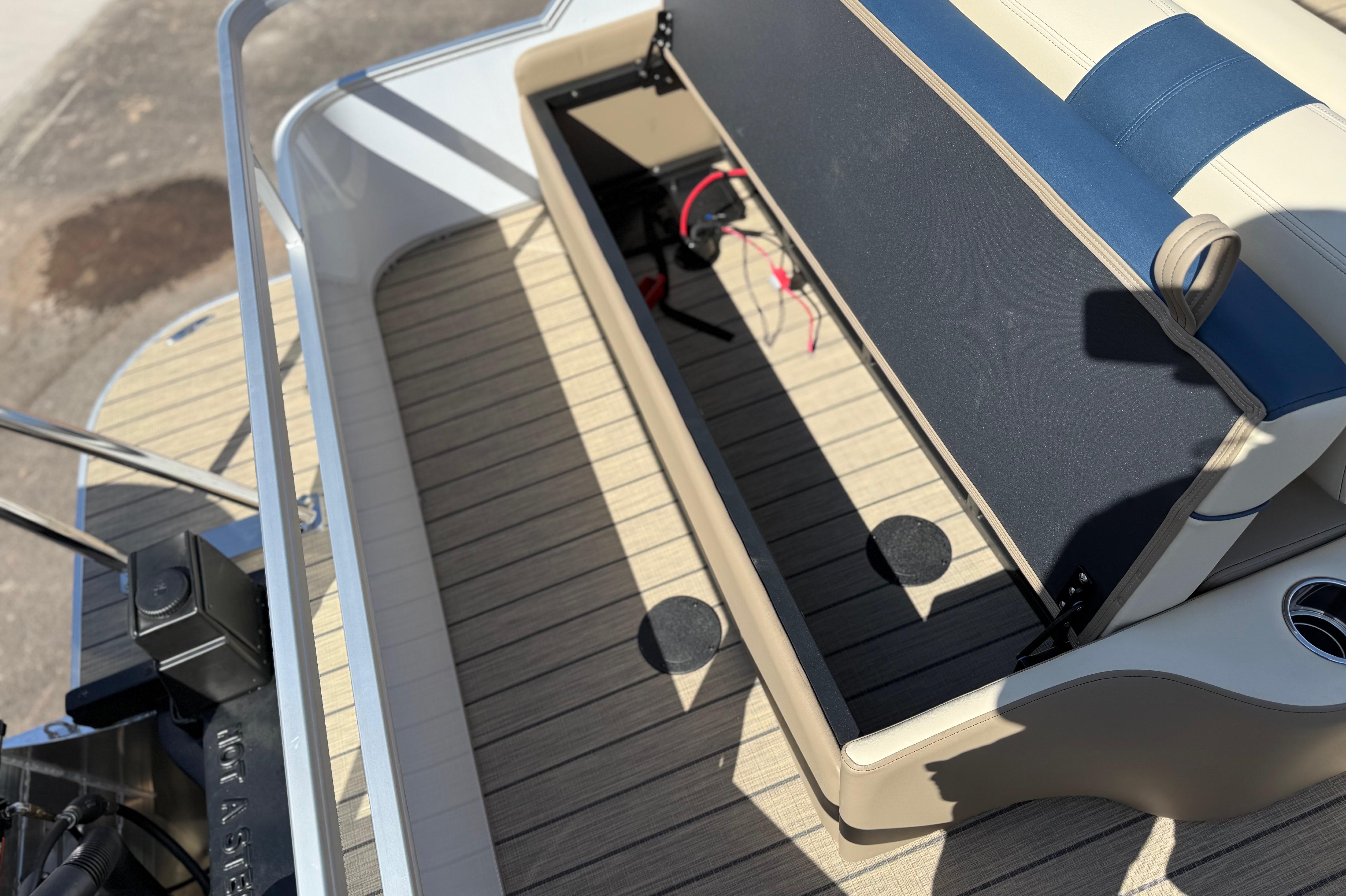 2026 SunCatcher Select 322SL boat interior with open storage compartment and seating.