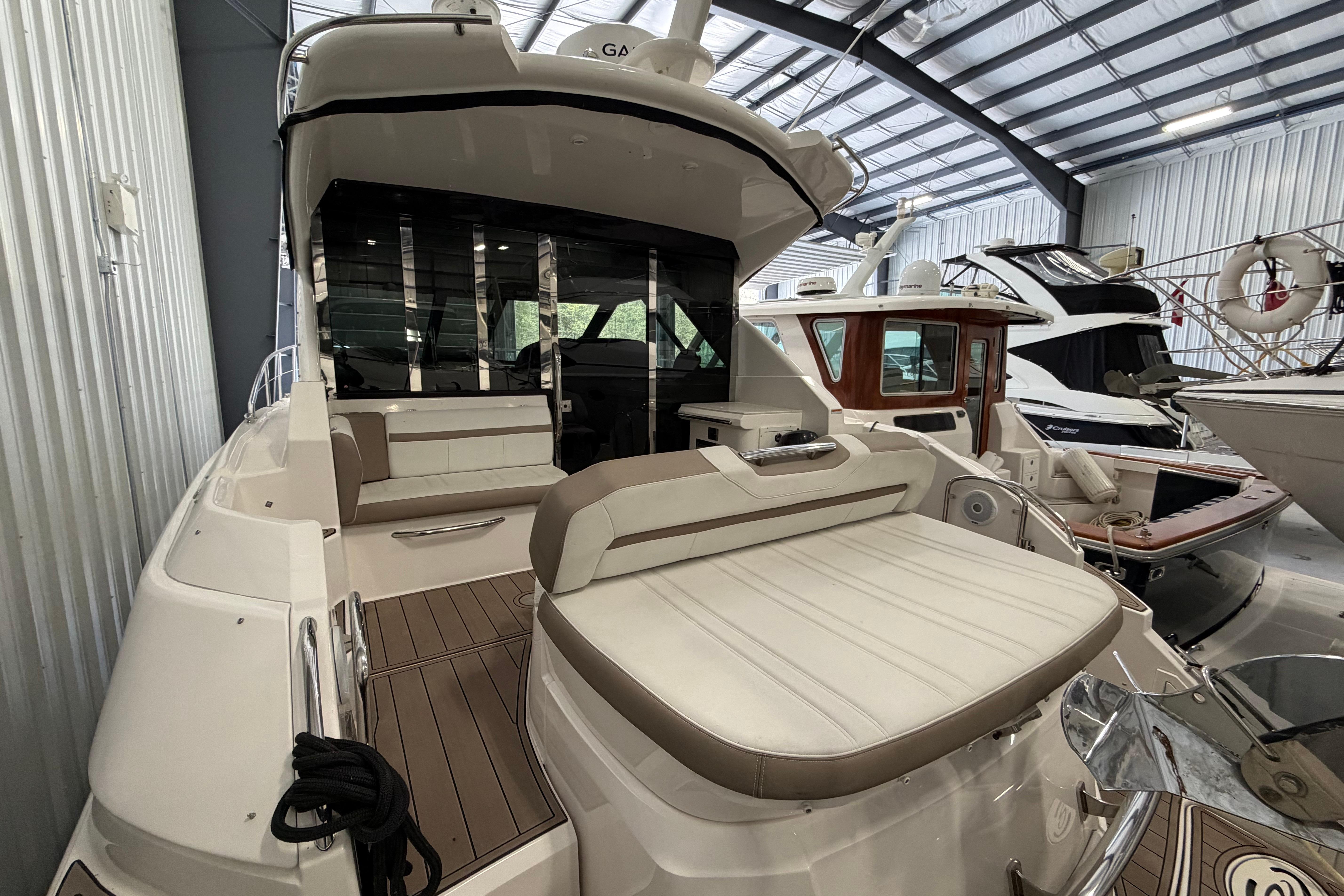 2018 Regal 42 Sport Coupe yacht in a marina, showcasing sleek design and luxurious seating.