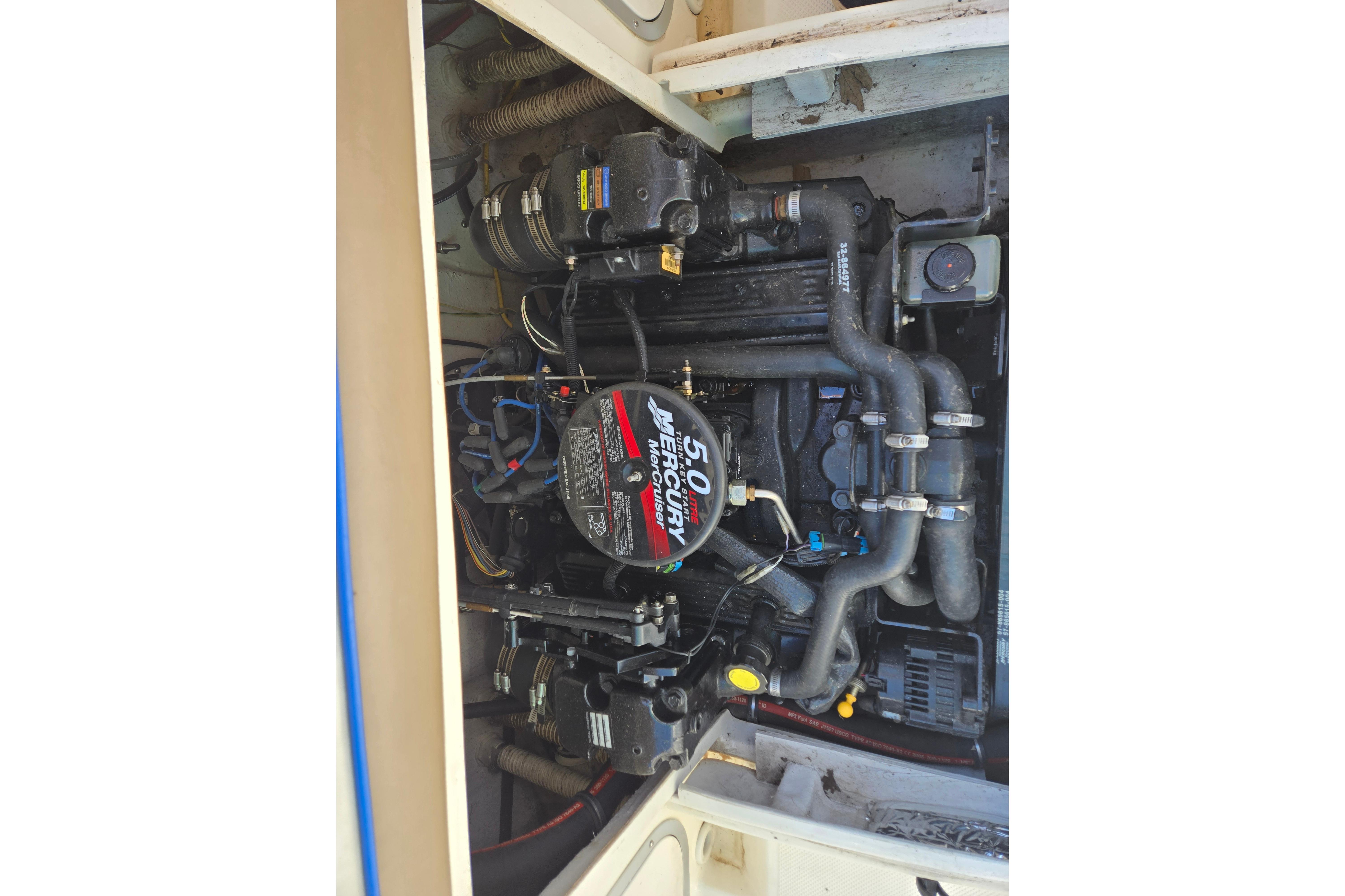 Engine compartment of a 2006 Bayliner 222 Classic boat, featuring a MerCruiser 5.0L engine.