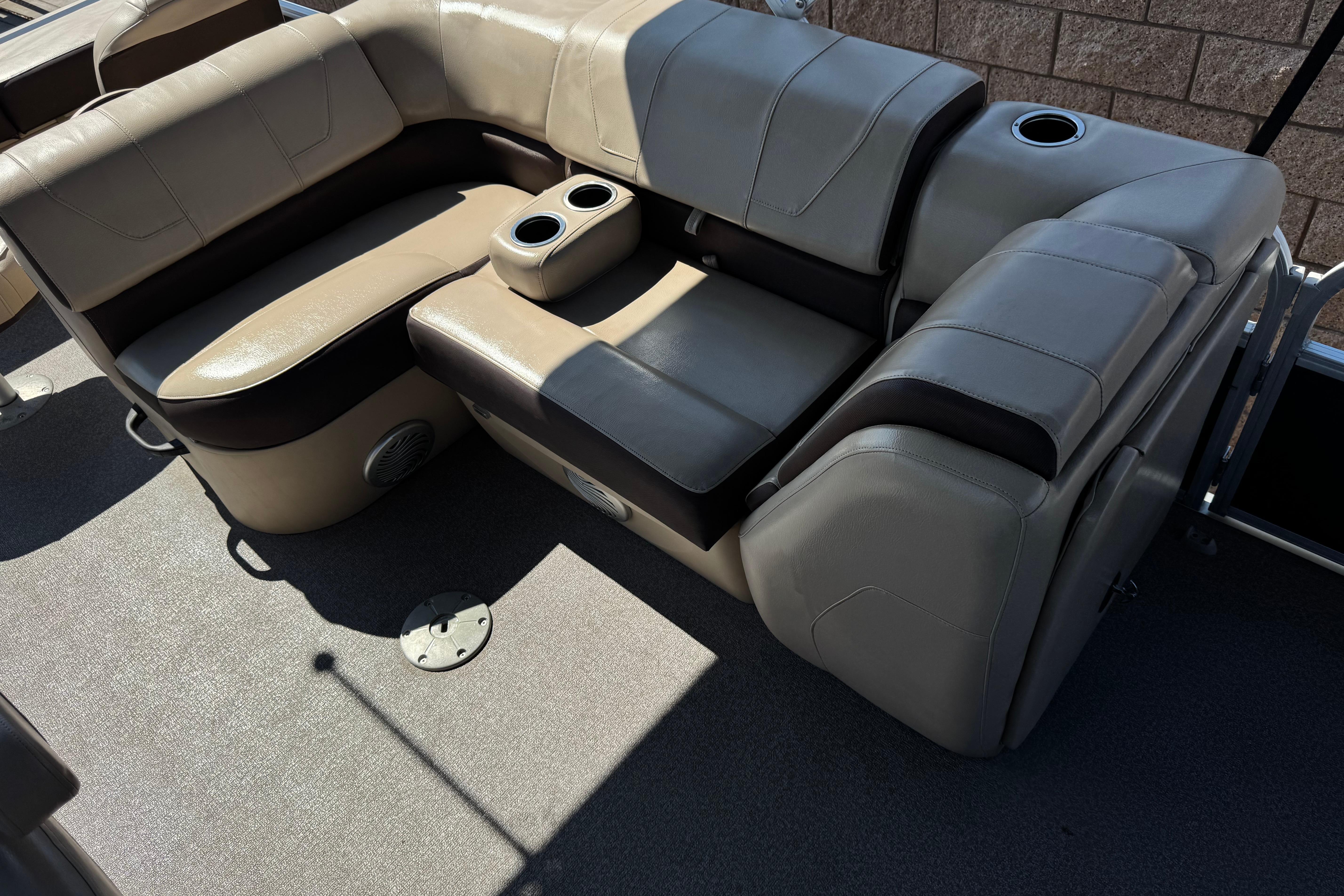 Luxurious seating on 2018 Sun Tracker SportFish 22 DLX pontoon boat with cup holders.