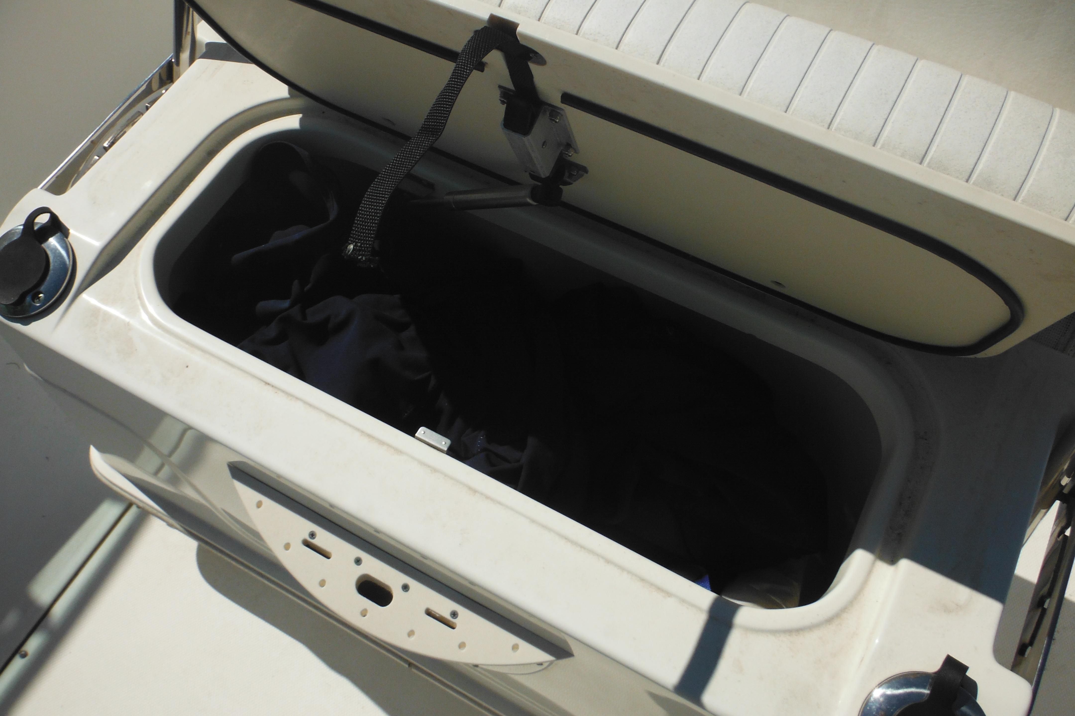 Open storage compartment on a 2009 Boston Whaler 200 Dauntless boat.