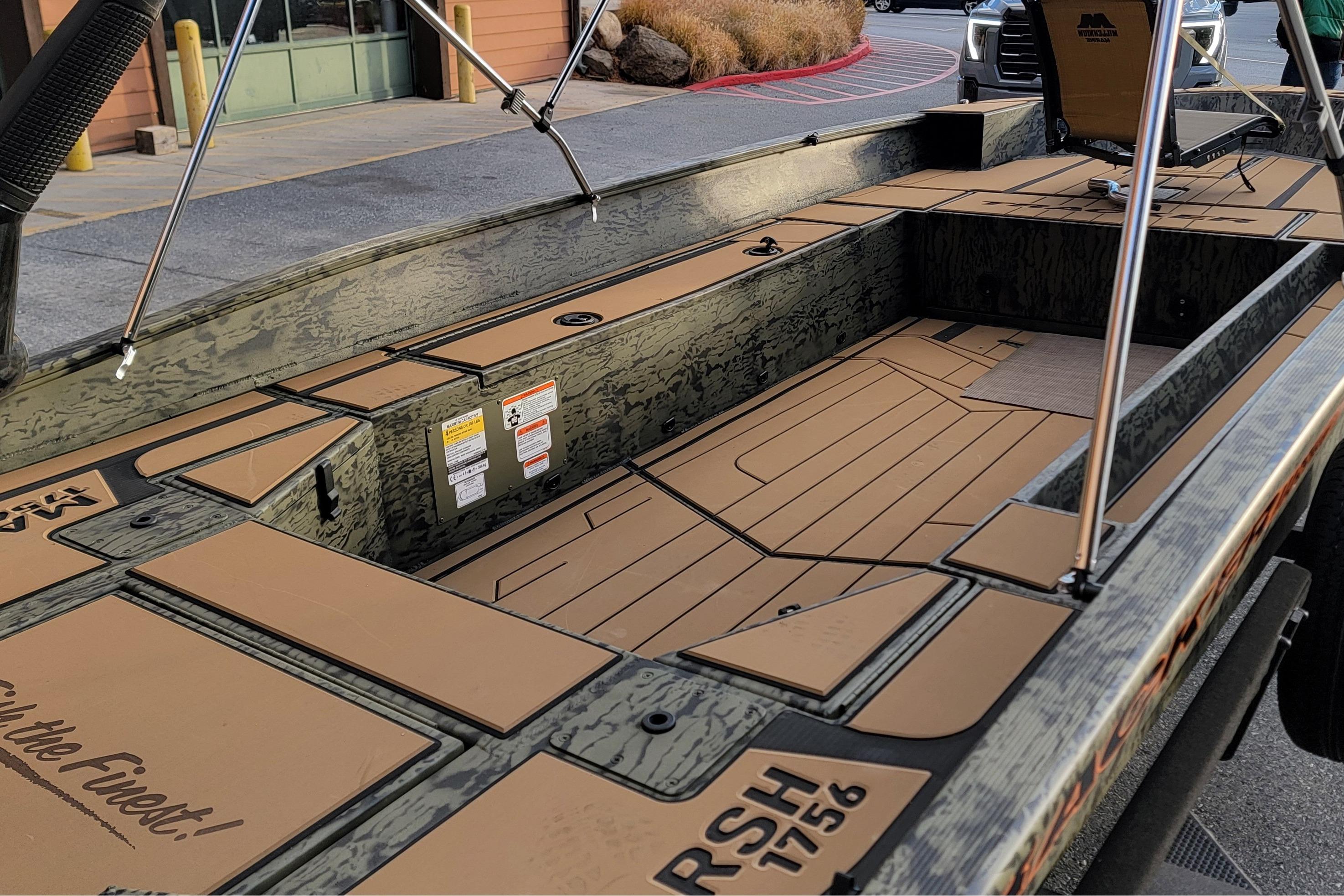 2026 Tracker Grizzly 1756 T Marsh boat interior with camouflage design and seating arrangement.