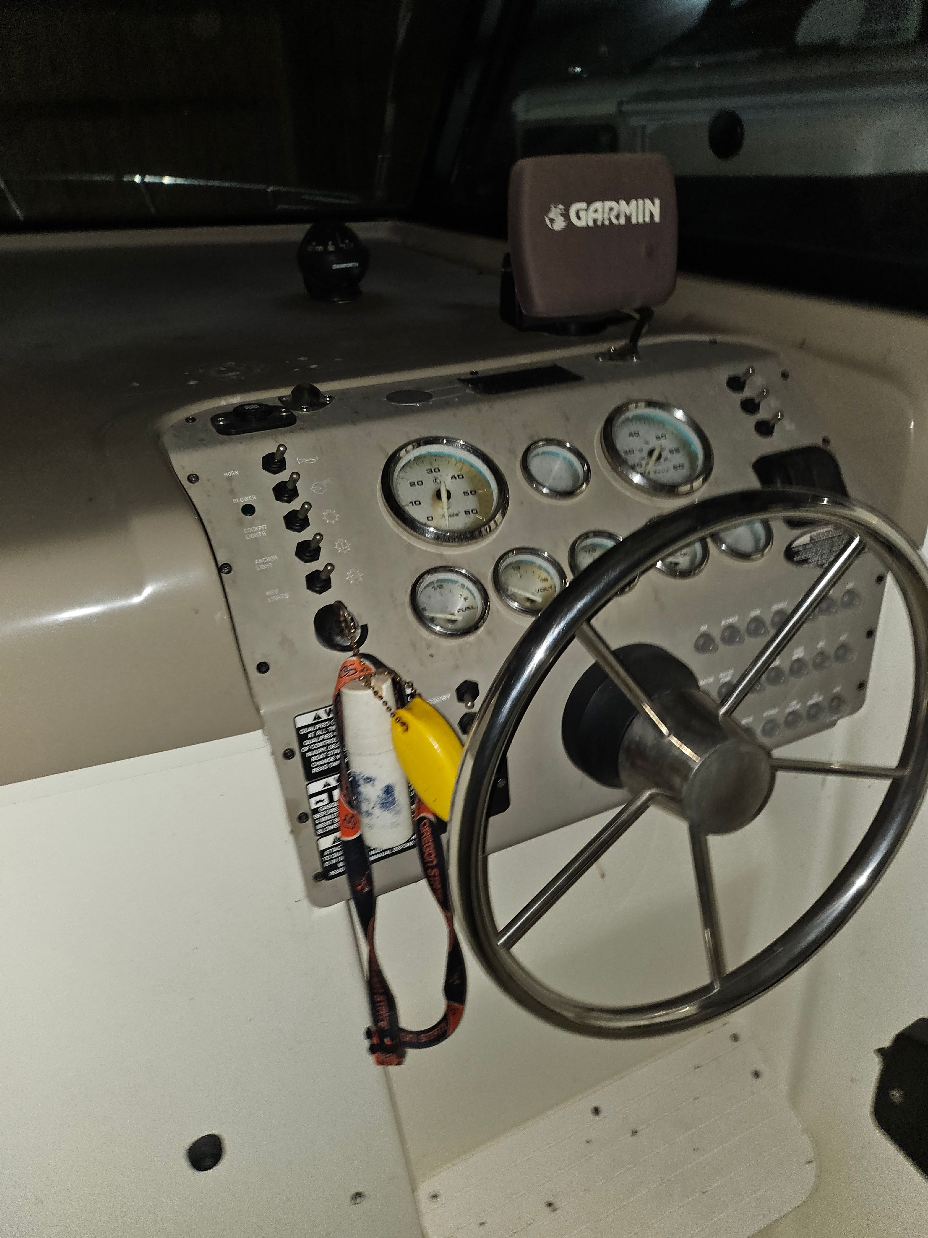The image shows the dashboard of a Bayliner 242 Ceara boat with a Garmin device.