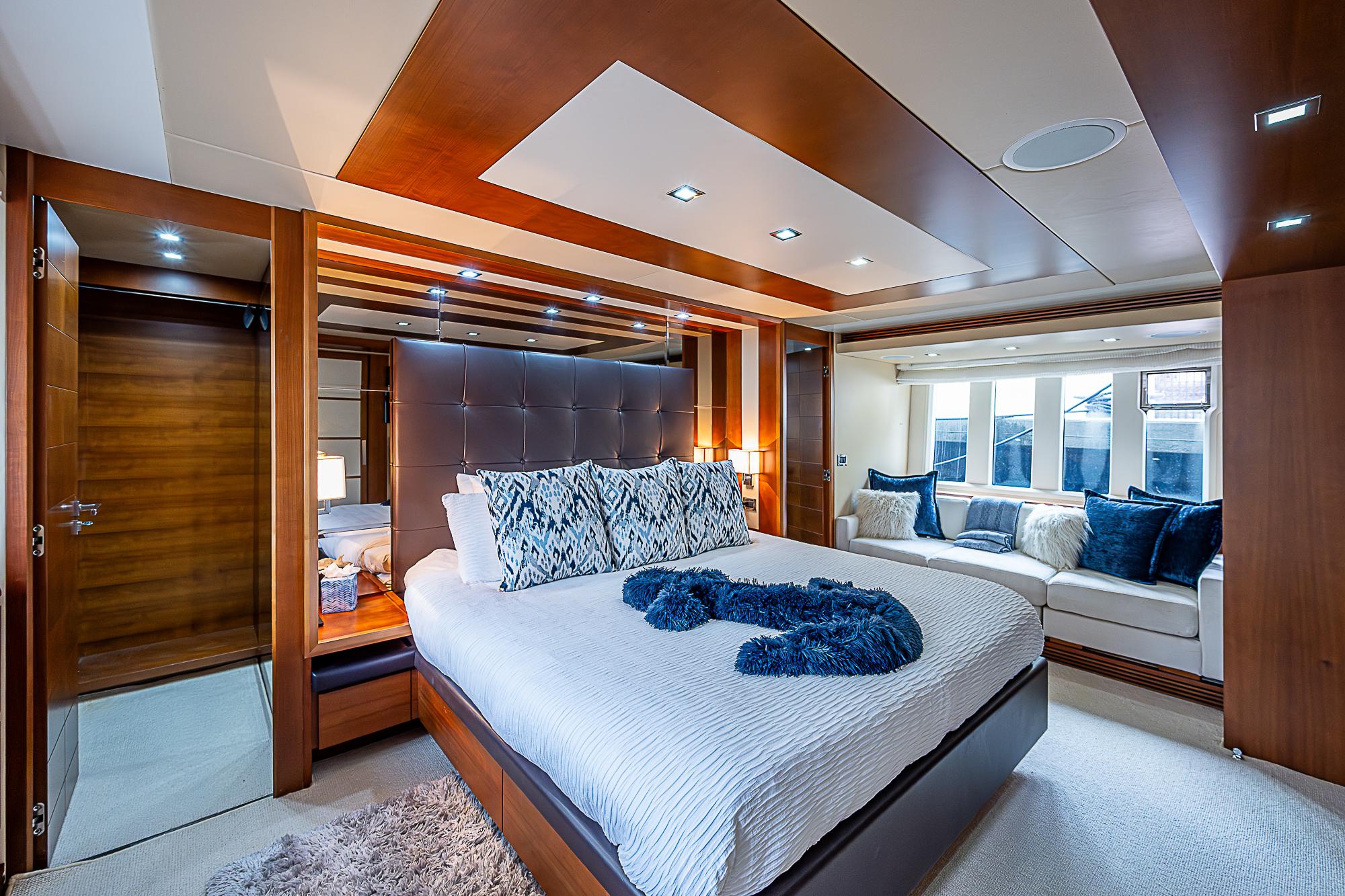 Luxurious bedroom interior of 2011 Azimut 82 yacht with modern design and plush furnishings.