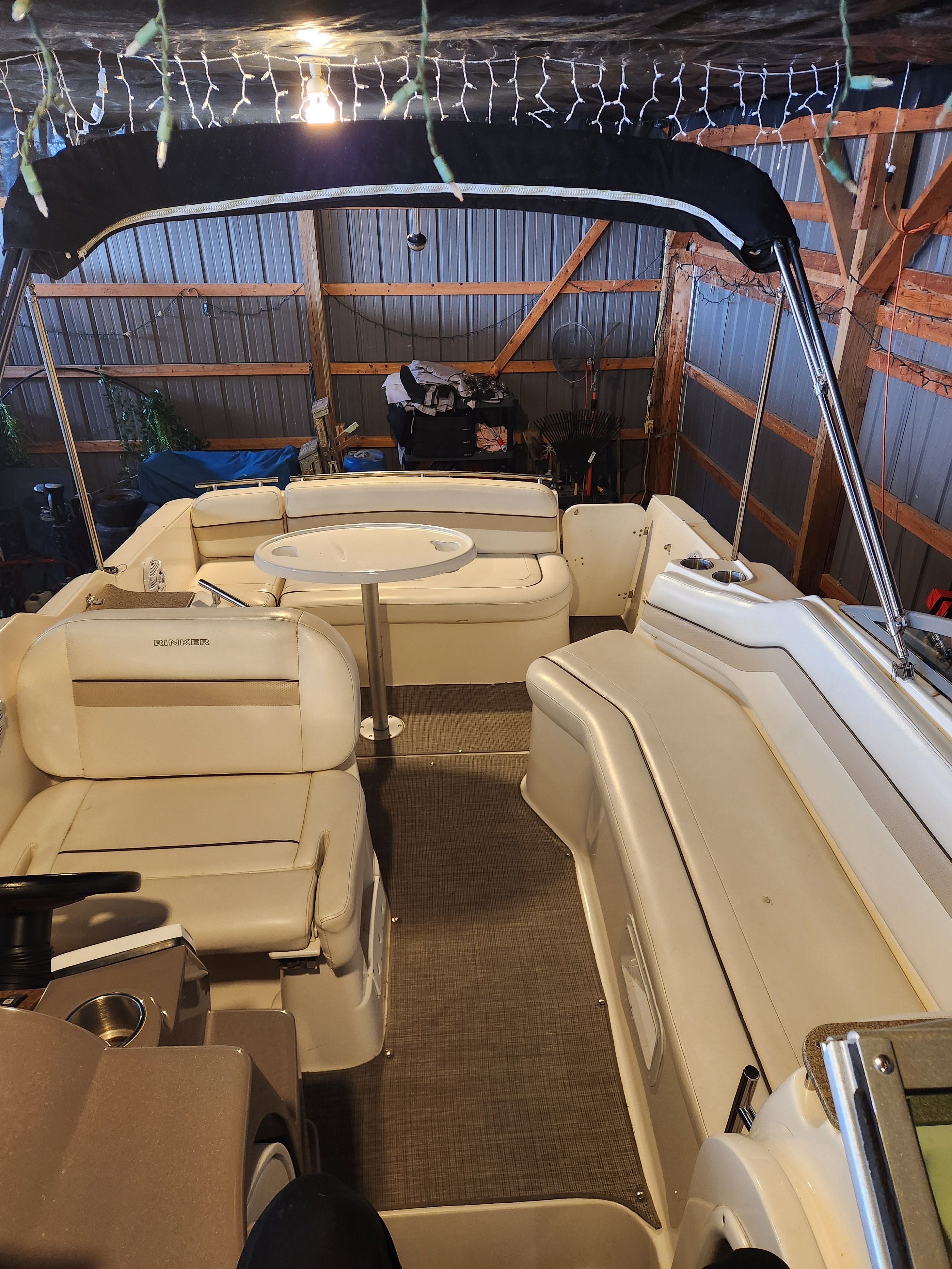 Interior of a 2006 Rinker 250 EC boat inside a barn.