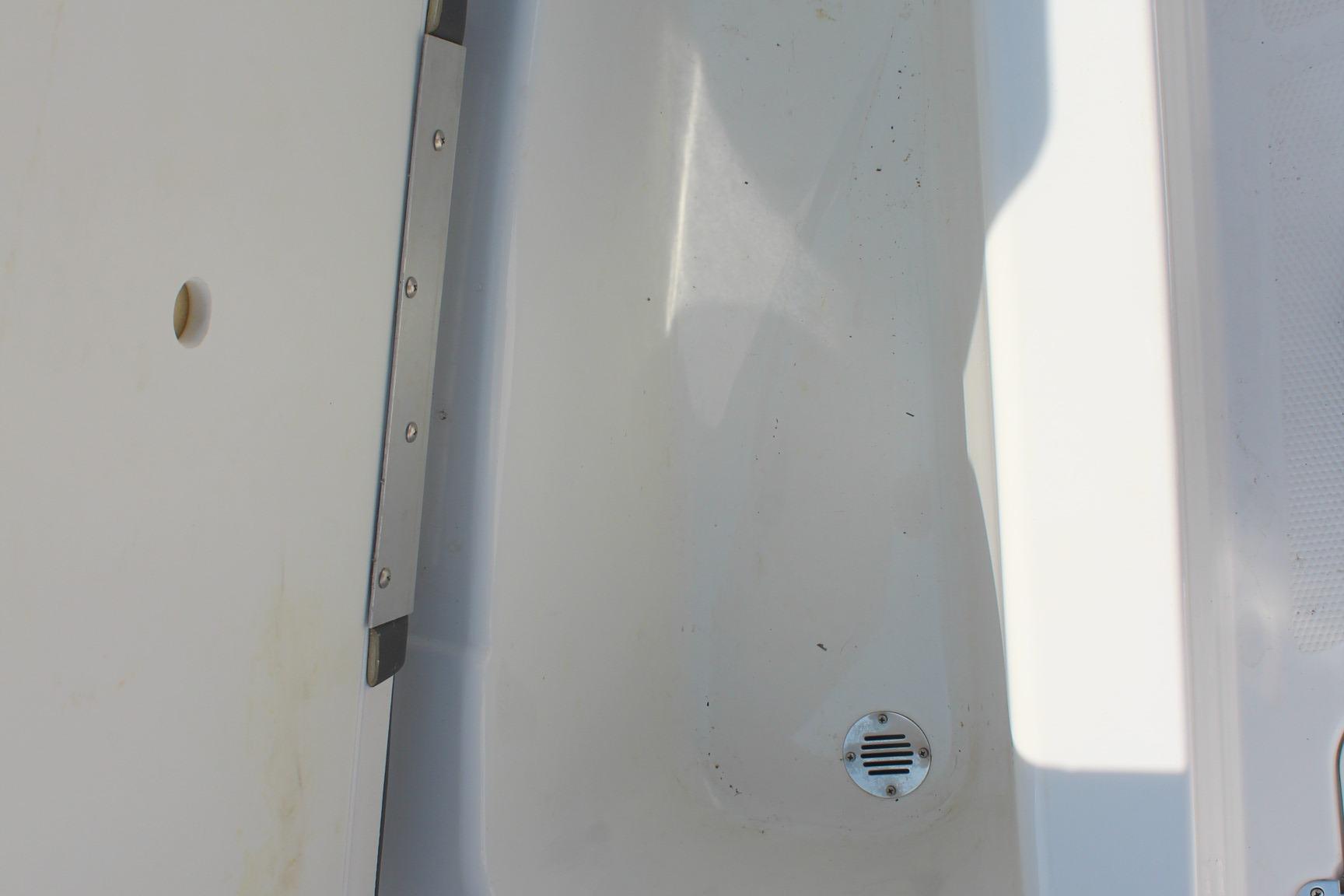 2023 Tahoe T16 boat interior detail with drain and metal trim.
