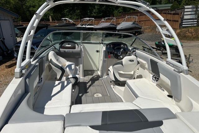 2023 Chaparral 23 SSi boat interior with white seating and steering console.