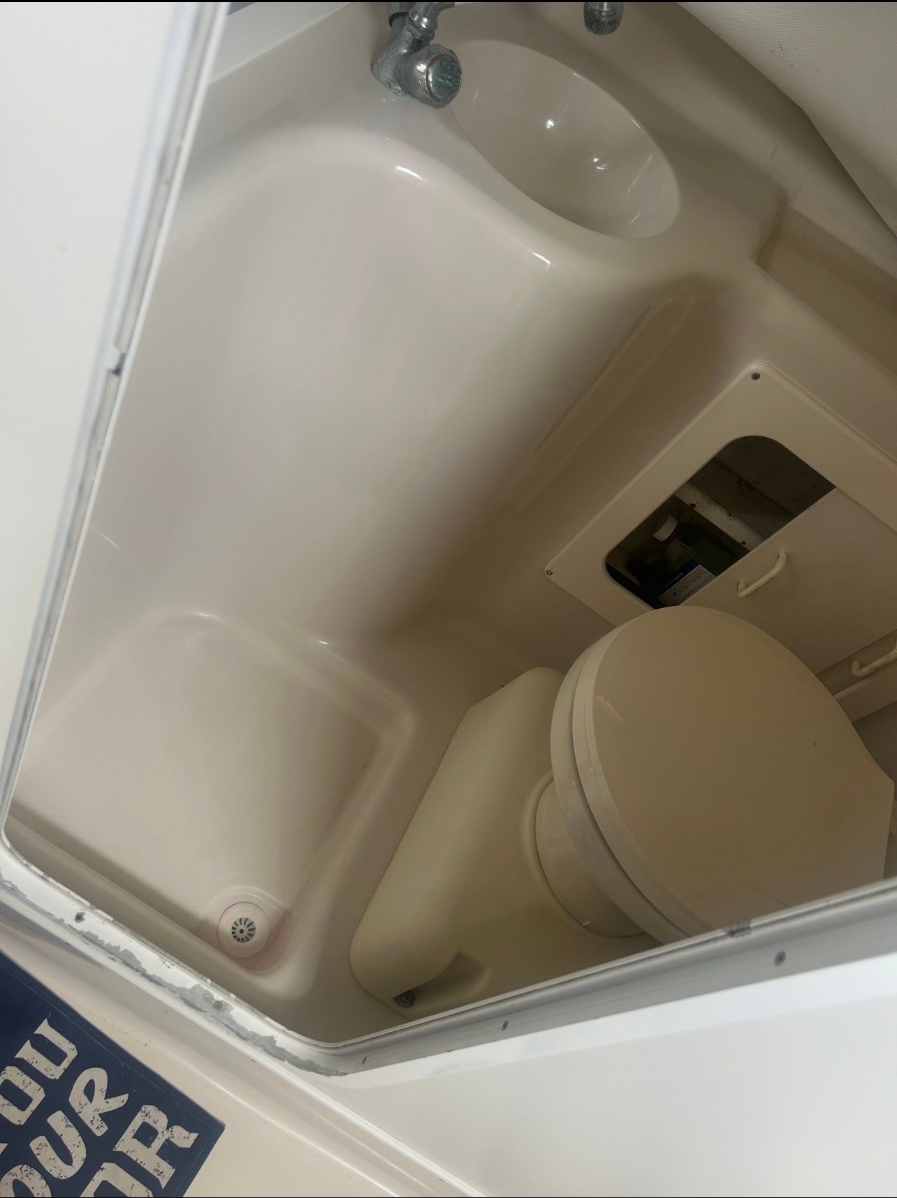 Interior view of a boat bathroom with a sink and toilet.