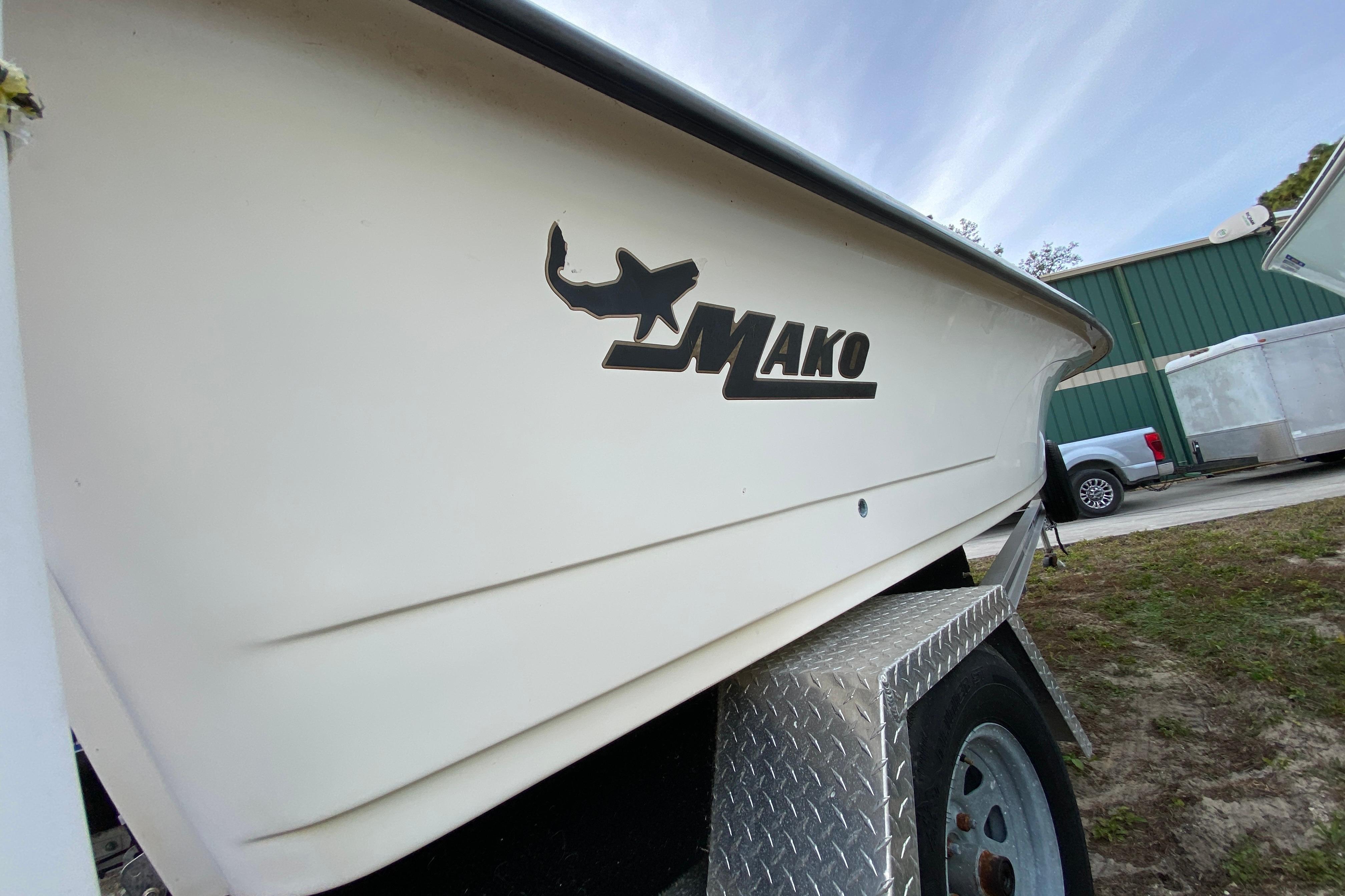 2006 Mako 191 Inshore boat on trailer, side view with logo visible.