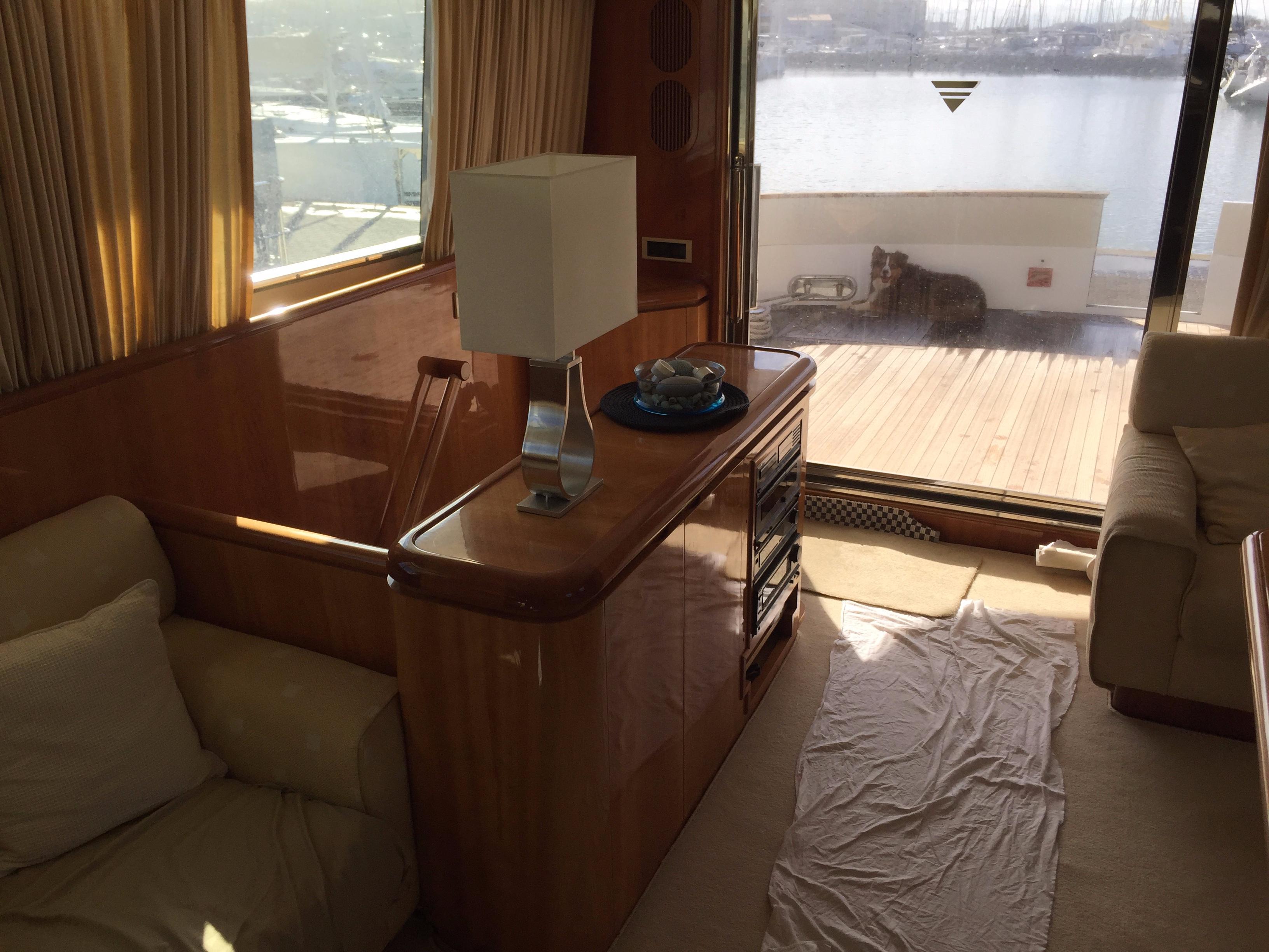 Luxurious interior of a 1994 Falcon 76 yacht with elegant wood finishes.