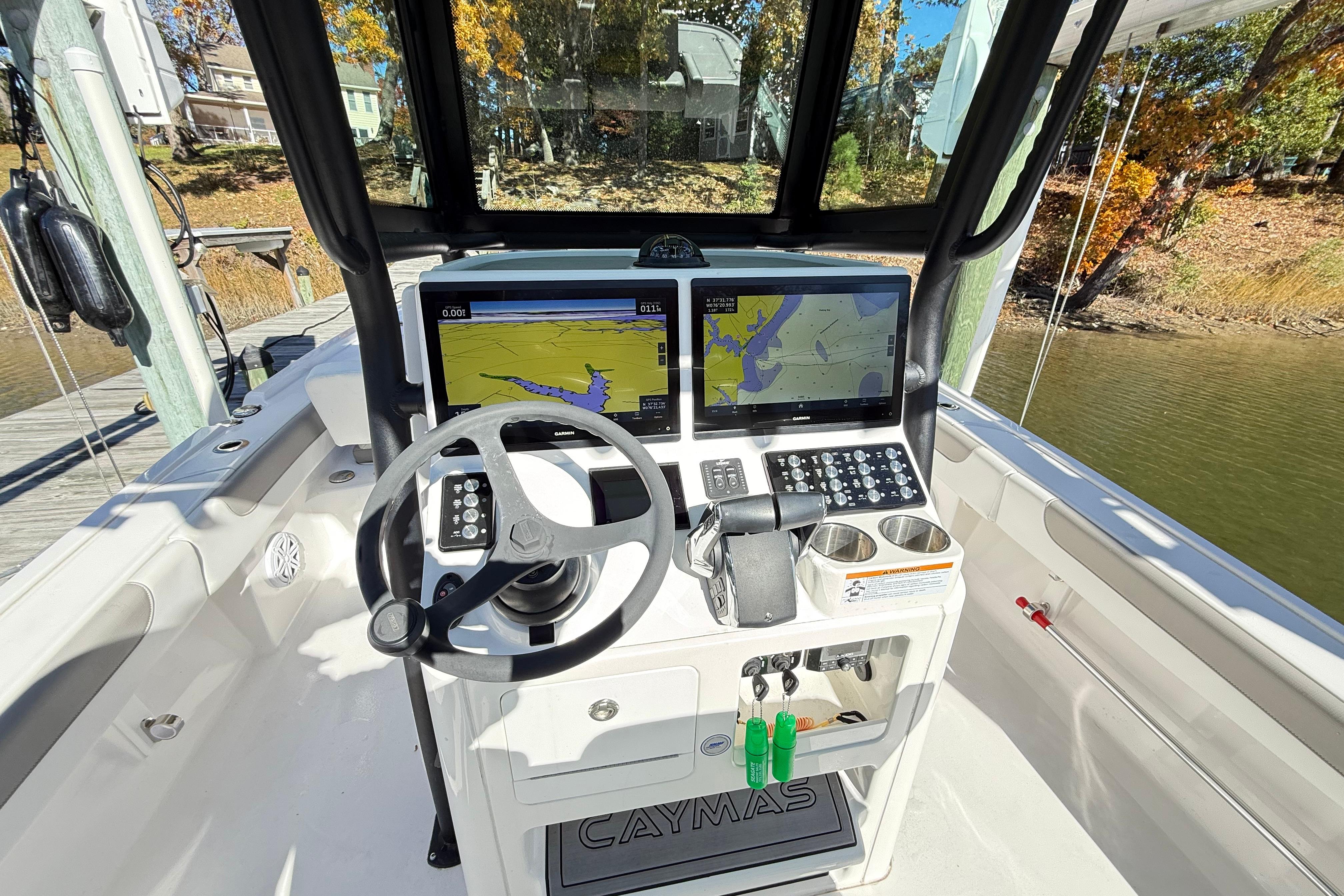 2023 Caymas 281 HB boat cockpit with advanced navigation system and steering wheel.