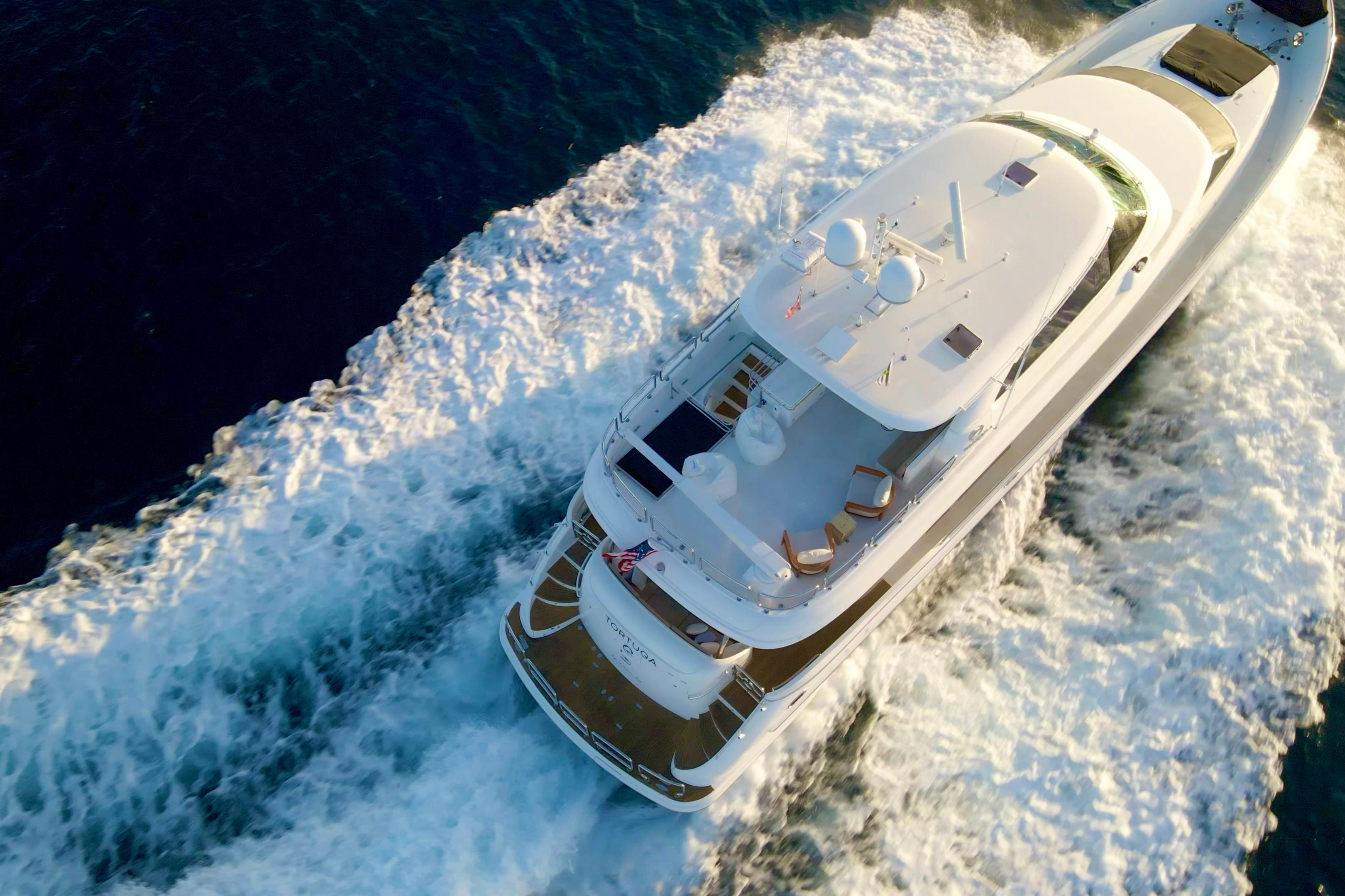 Aerial view of 2011 Horizon E88 yacht cruising through ocean waves.
