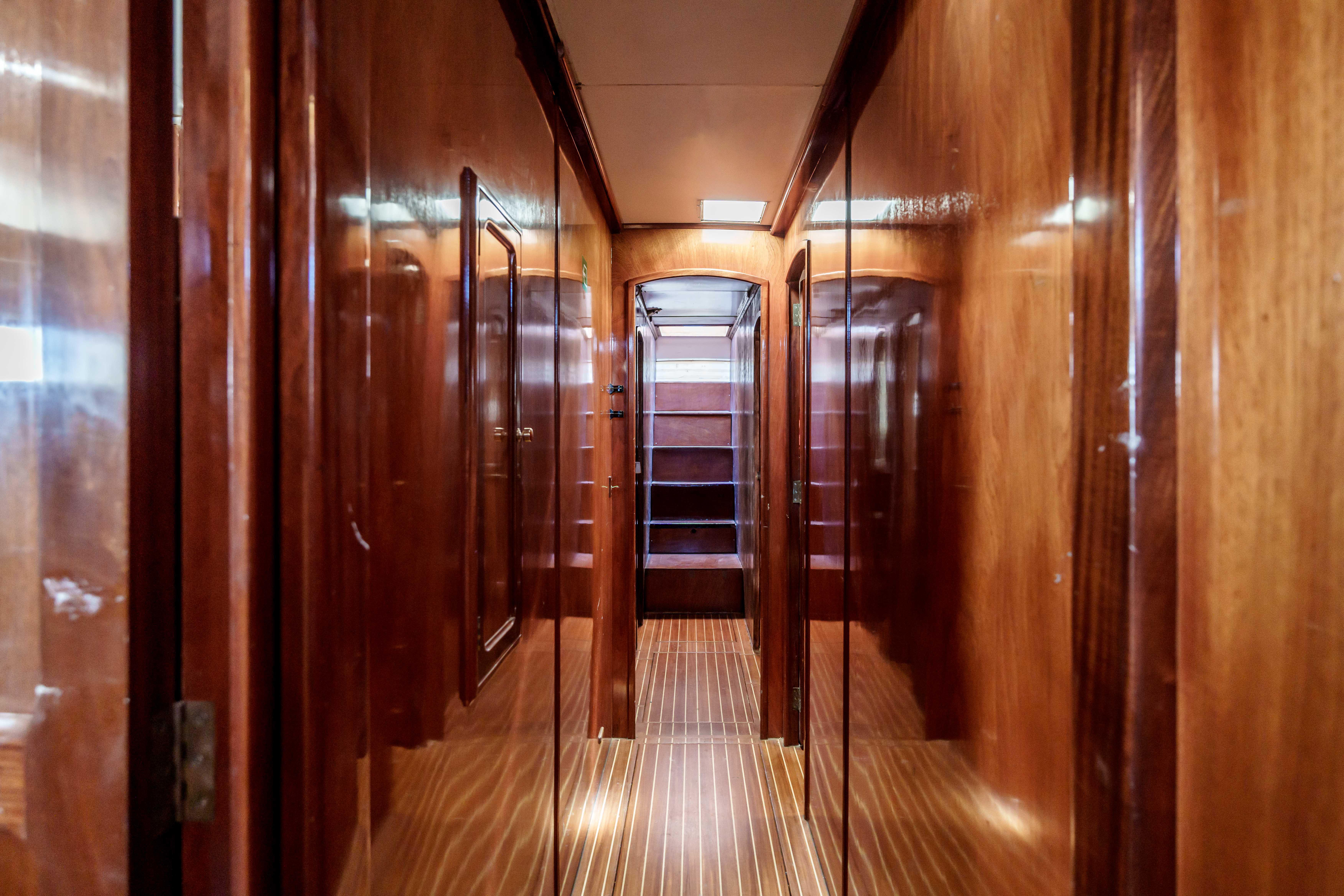 Luxurious wooden interior hallway of 1983 Cavalier 92 yacht.