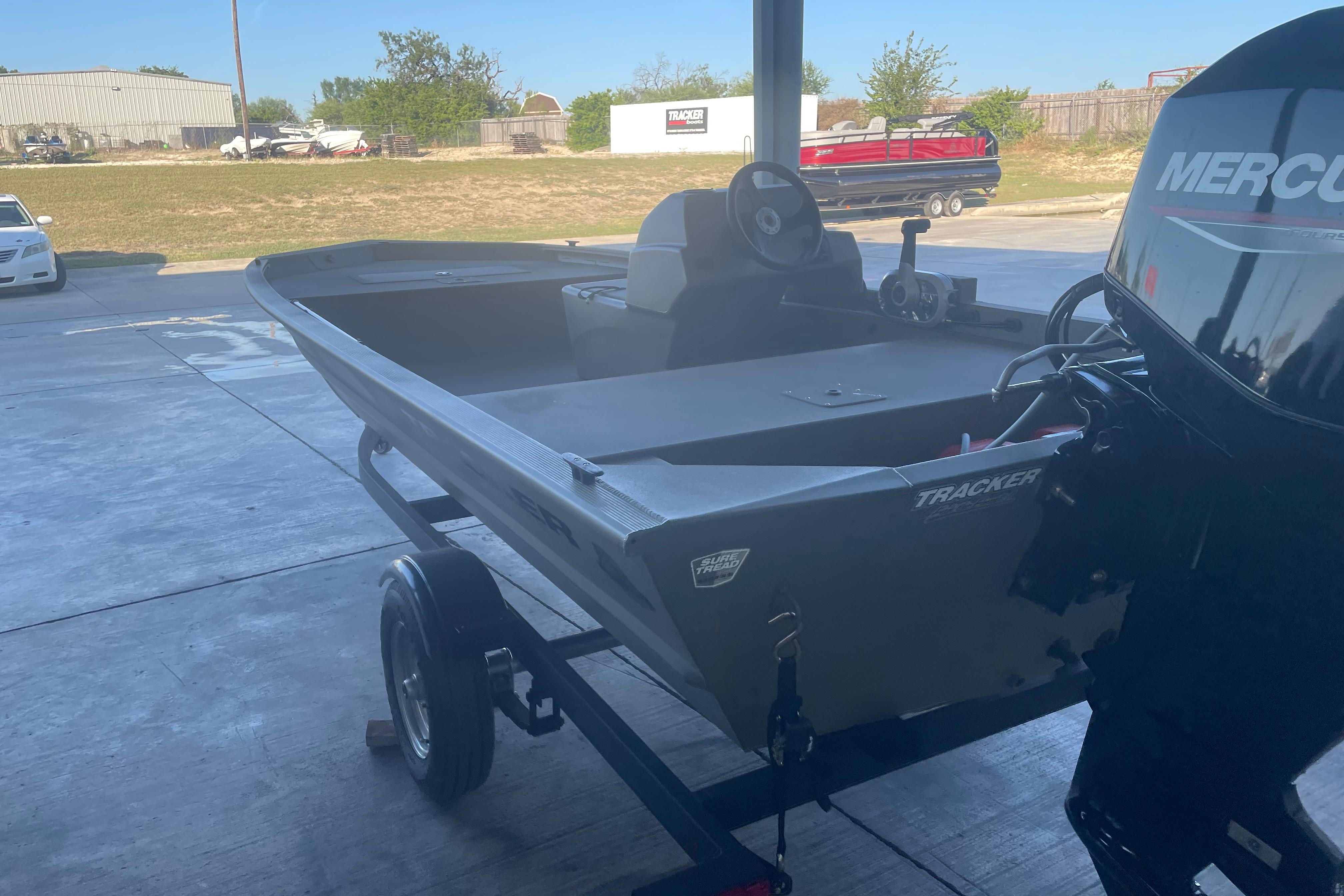 2026 Tracker Grizzly 1648 SC boat on trailer with Mercury outboard motor.